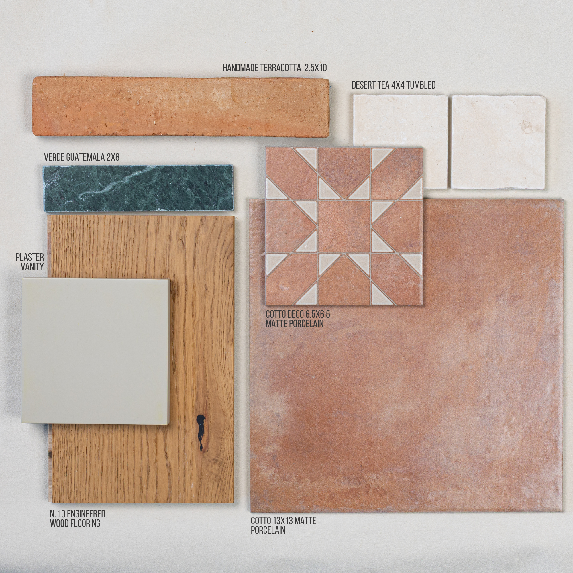 Assortment of tiles including terracotta, porcelain, marble, and engineered wood samples arranged on neutral background