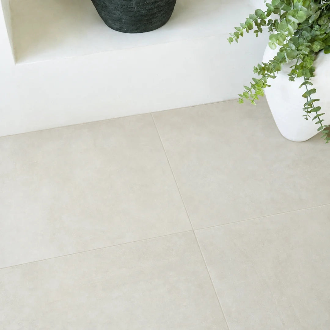 Light beige large format tiles in a minimalist interior with potted greenery