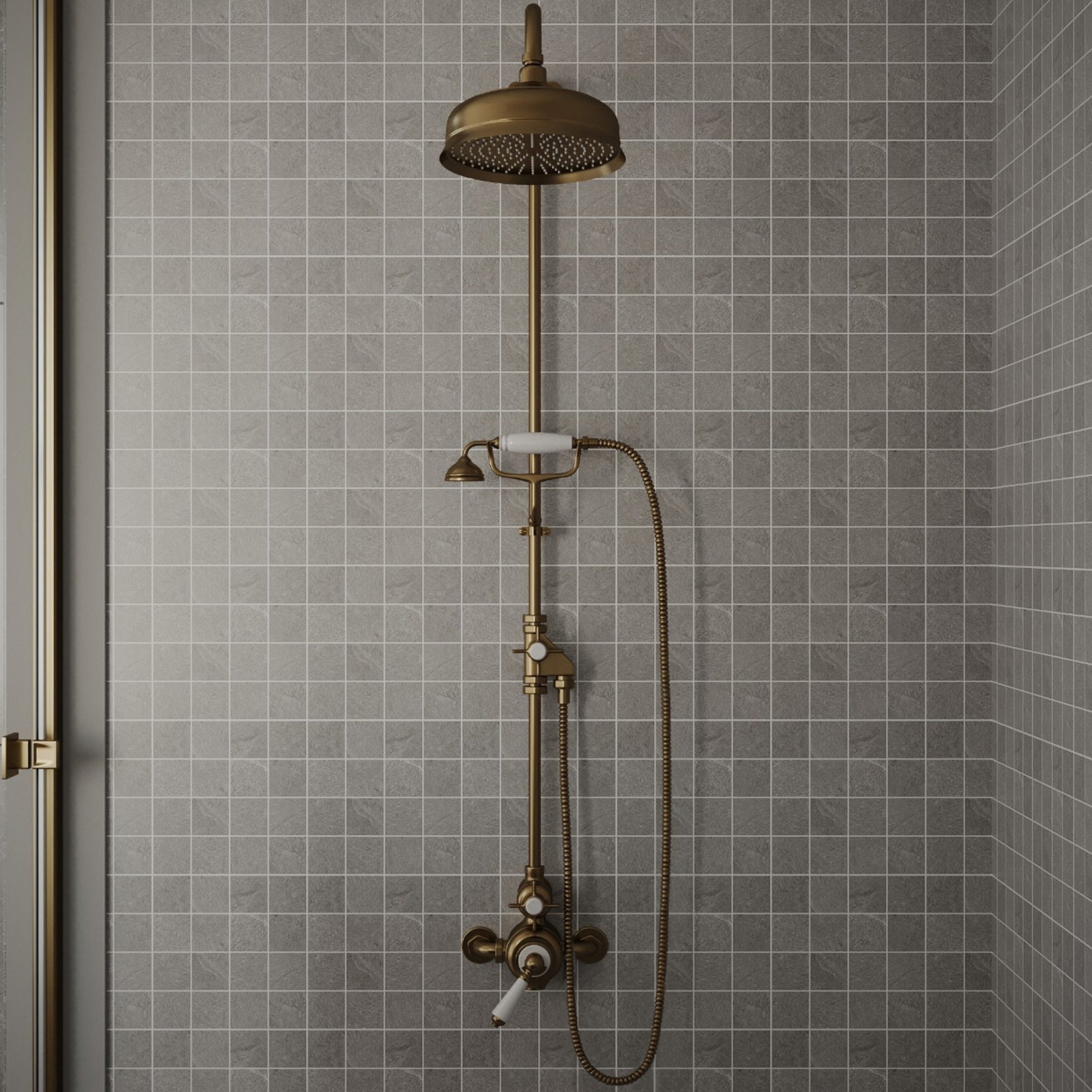 Antique brass rain showerhead with handheld sprayer mounted on gray square ceramic tile wall