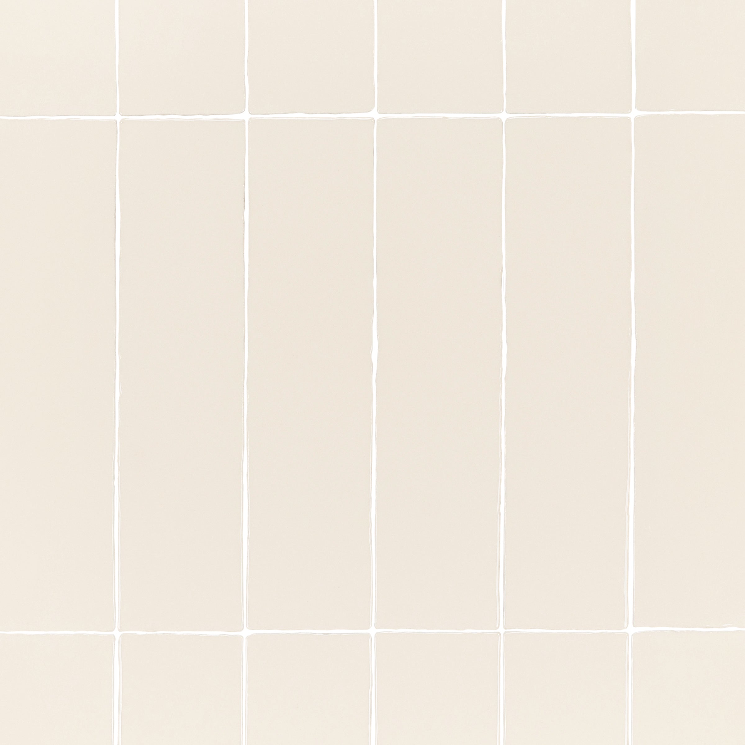 Dark White 3x12 Glossy Ceramic Tile in warm beige with subtle surface undulations from Seville Glossy Ceramic Tiles collection