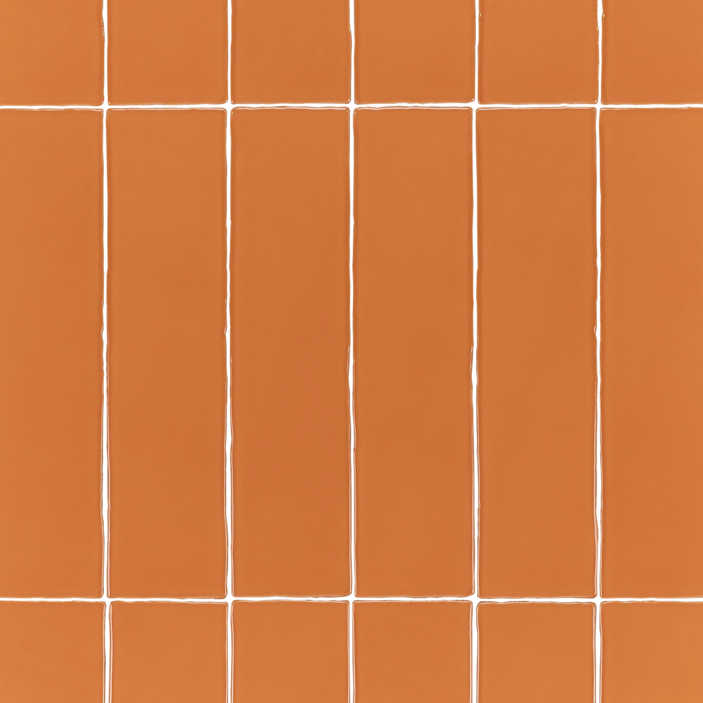 Terracotta 3x12 Glossy Ceramic Tile in warm burnt orange with vibrant gloss and subtly irregular edges from Seville Glossy Ceramic Tiles