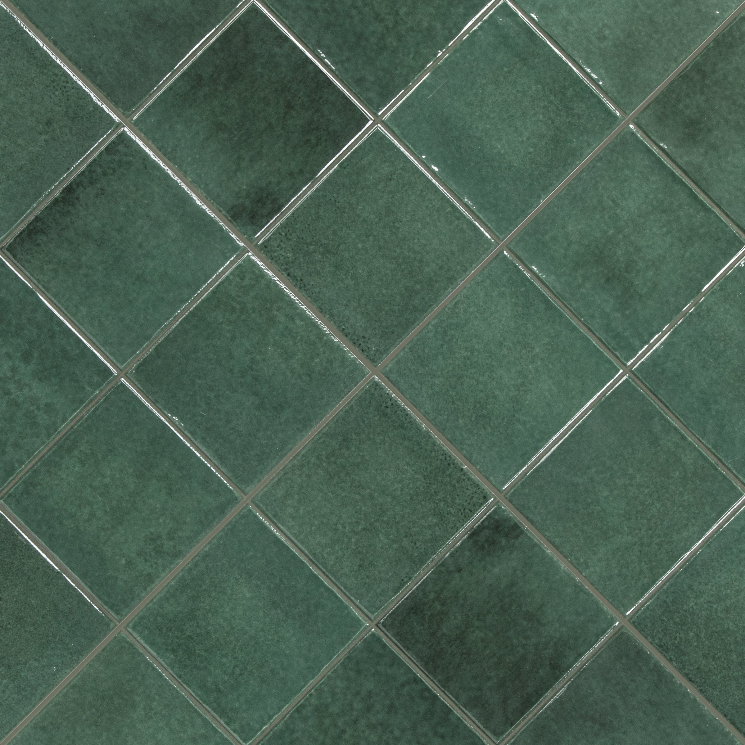 green ceramic tiles arranged diagonally with subtle texture and visible grout lines