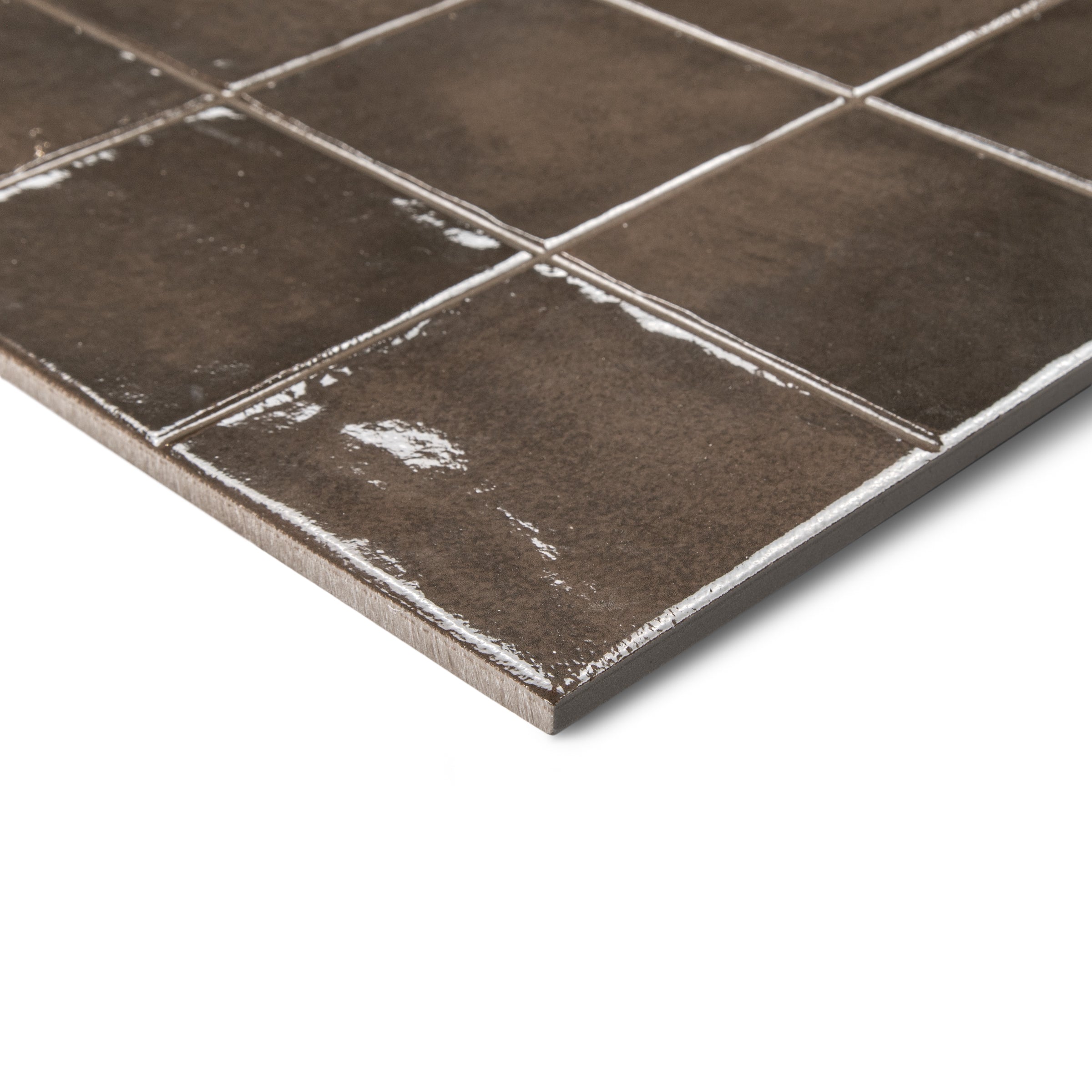 Close-up view of glossy dark brown ceramic tiles with visible grout lines on white background