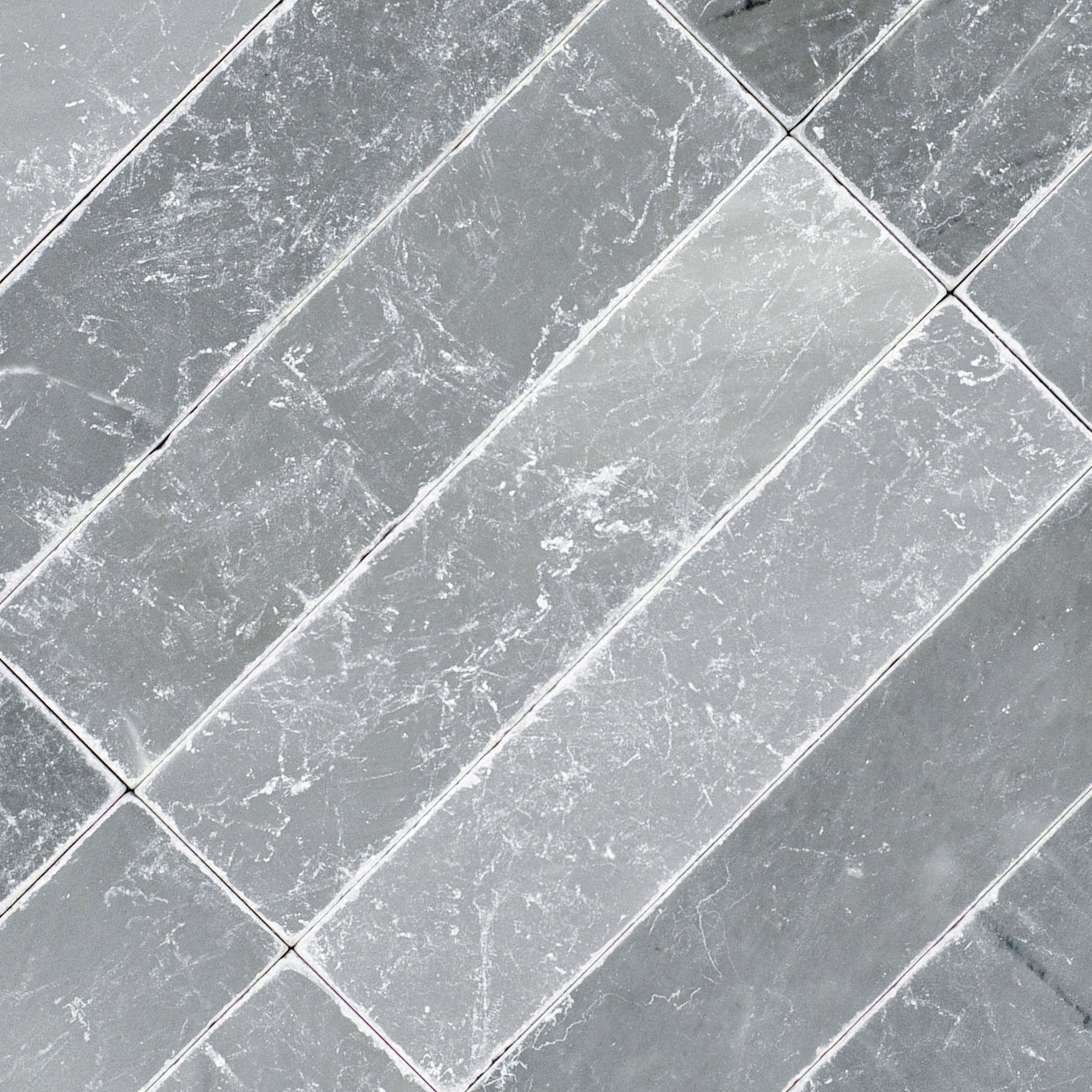 Bardiglio 2x8 Tumbled Marble Tile in gray with subtle white veining from Tumbled Natural Stone Tiles Stone New Arrivals