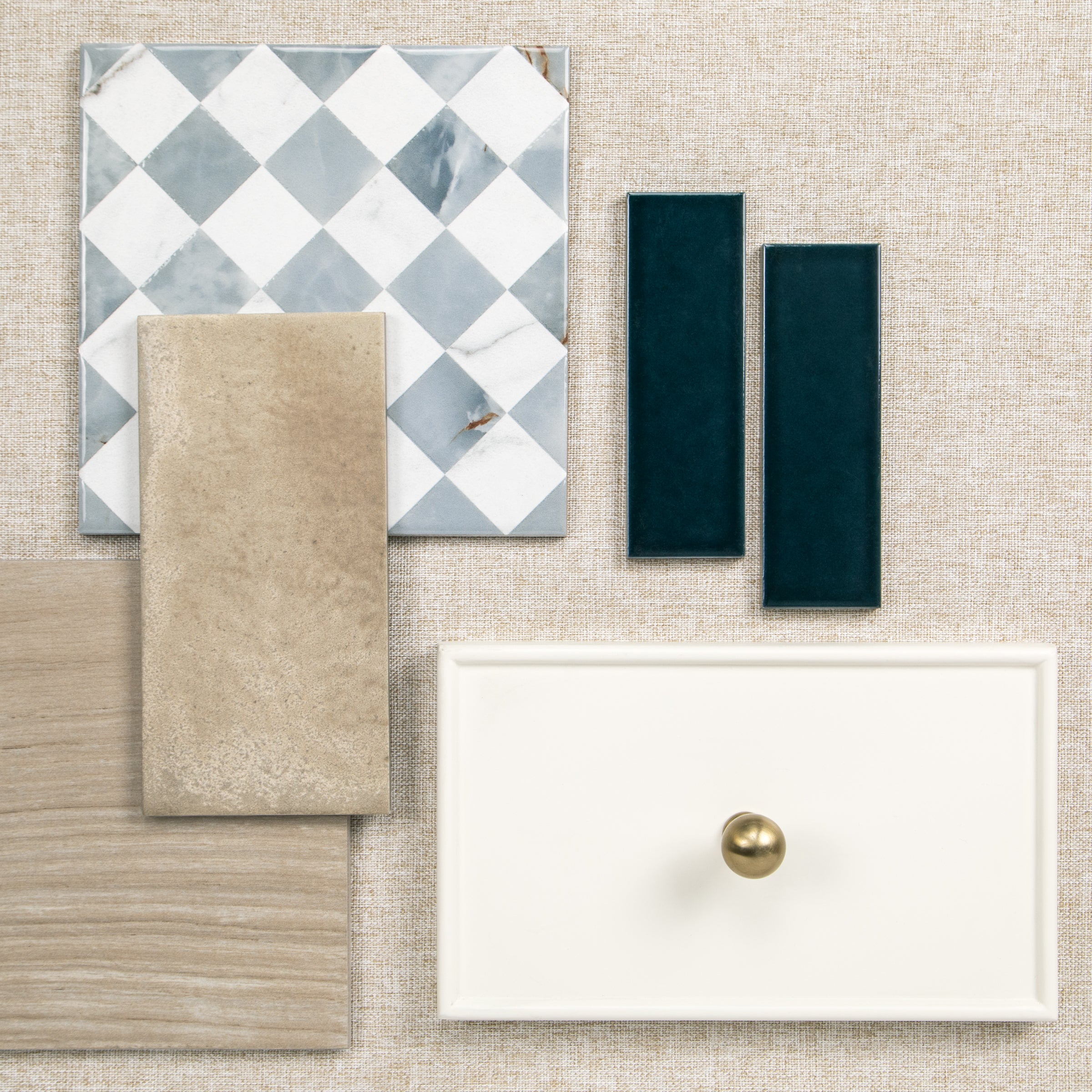 Tile and wood flooring samples beside a white drawer with a brass knob