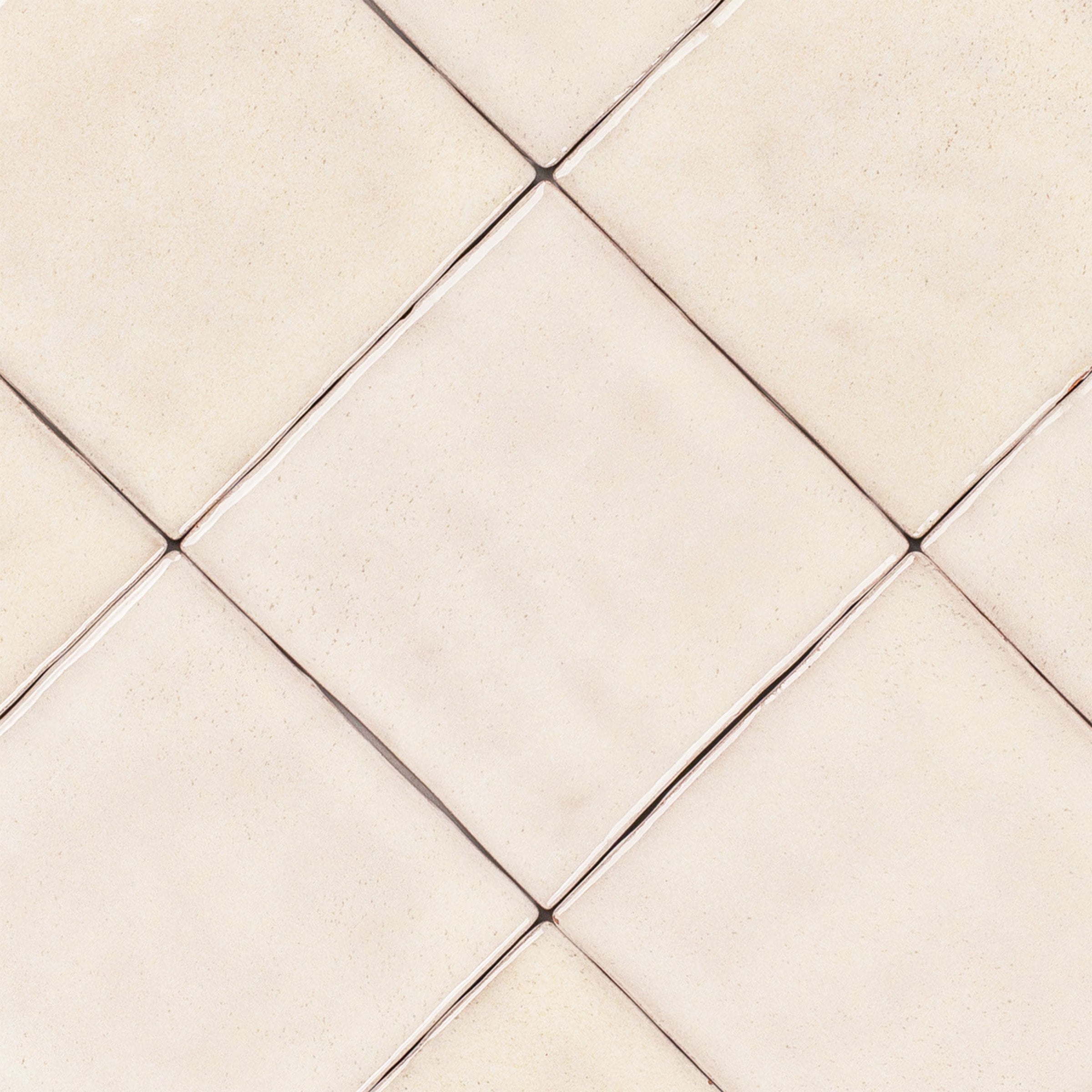Bone 4x4 Glossy Ceramic Tile in beige with handcrafted Moroccan-inspired texture from Small Format Tiles and Zel Glazed Ceramic Tiles collections