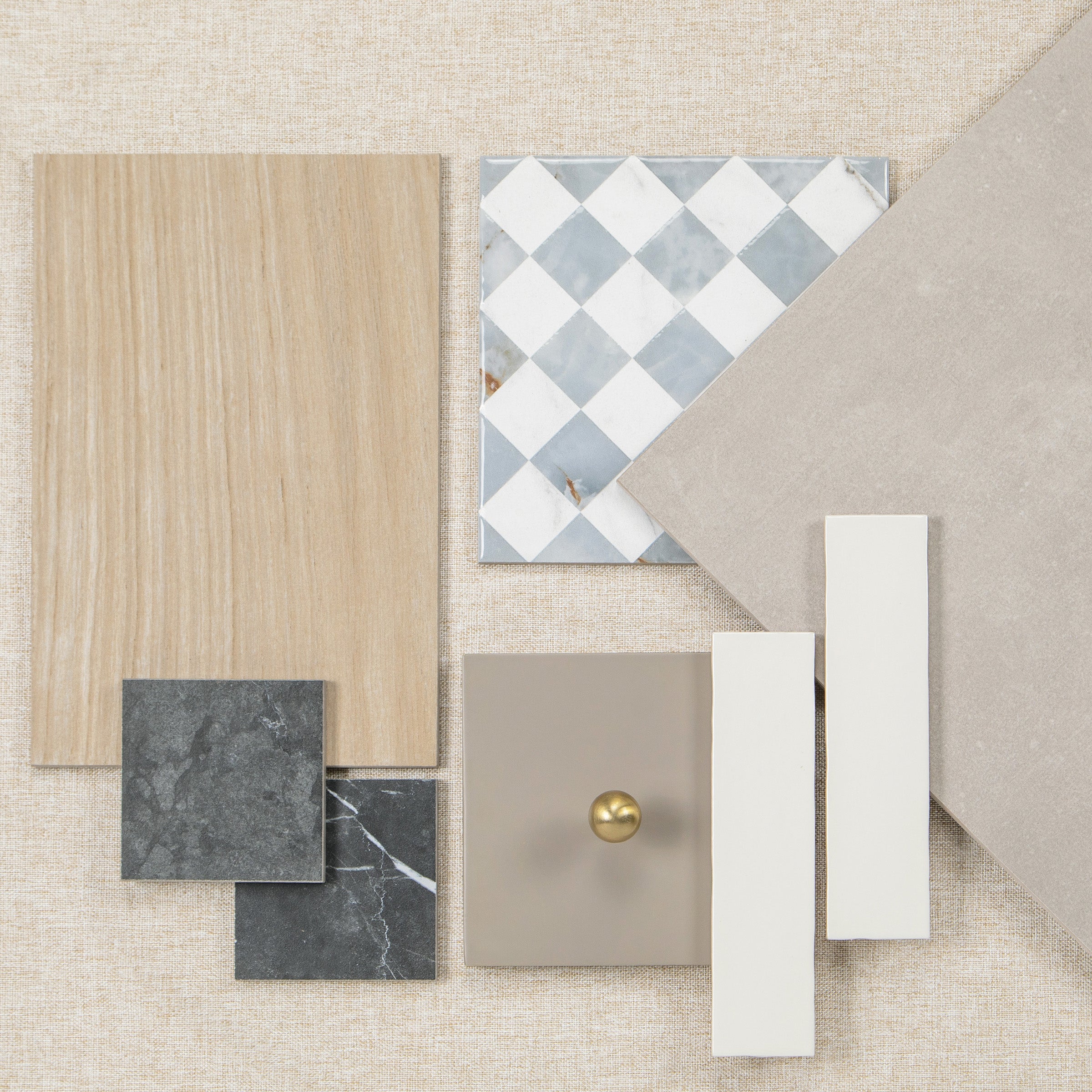 Overhead arrangement of wood flooring, patterned tiles, stone samples, and neutral finish swatches on a textured surface