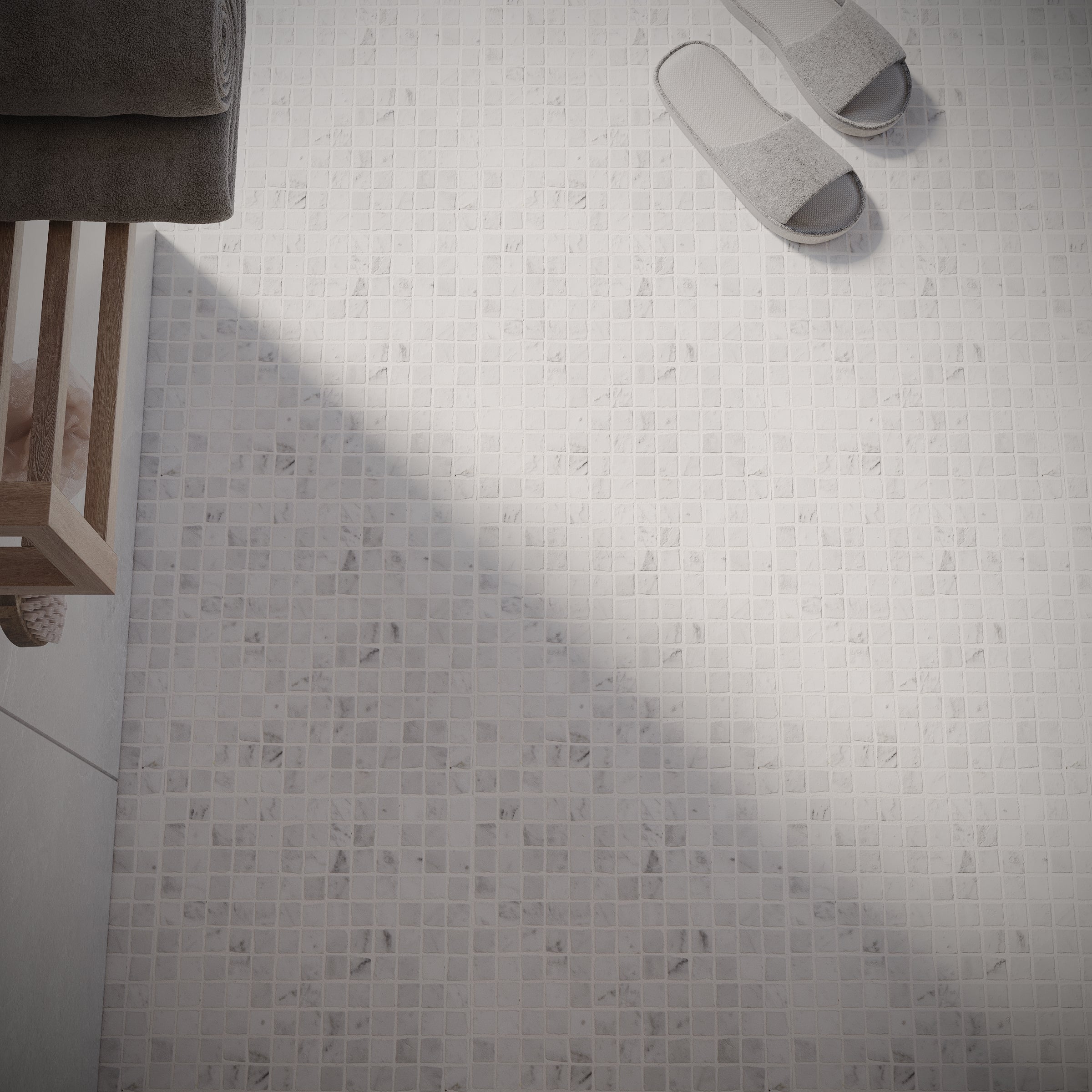 Carrara 1x1 Hand Chipped Marble Mosaic in gray and white tones on bathroom floor from Marble Tiles Stone New Arrivals