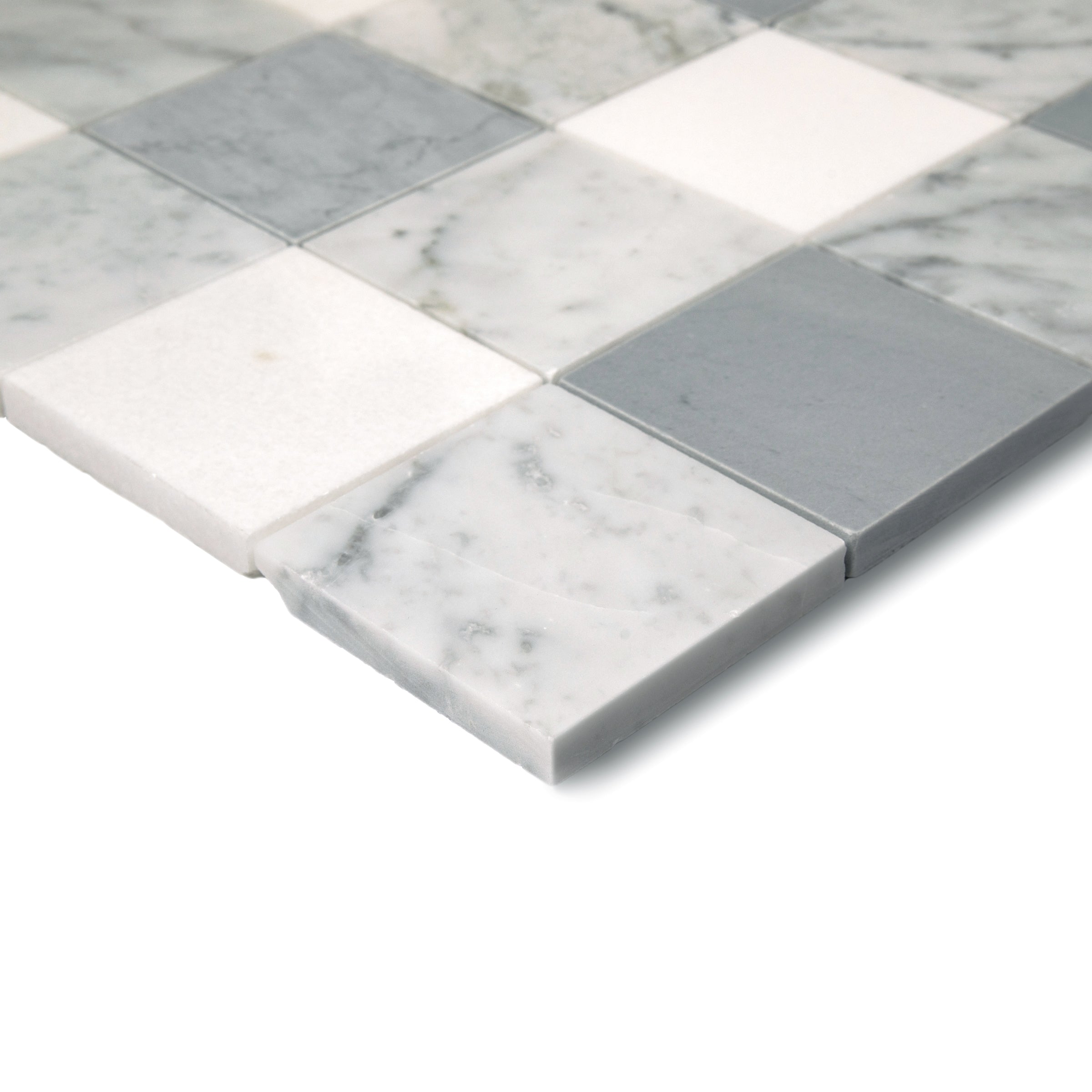 Close-up of a gingham-style mosaic with smooth white, gray, and marble-inspired ceramic tiles arranged in a grid pattern