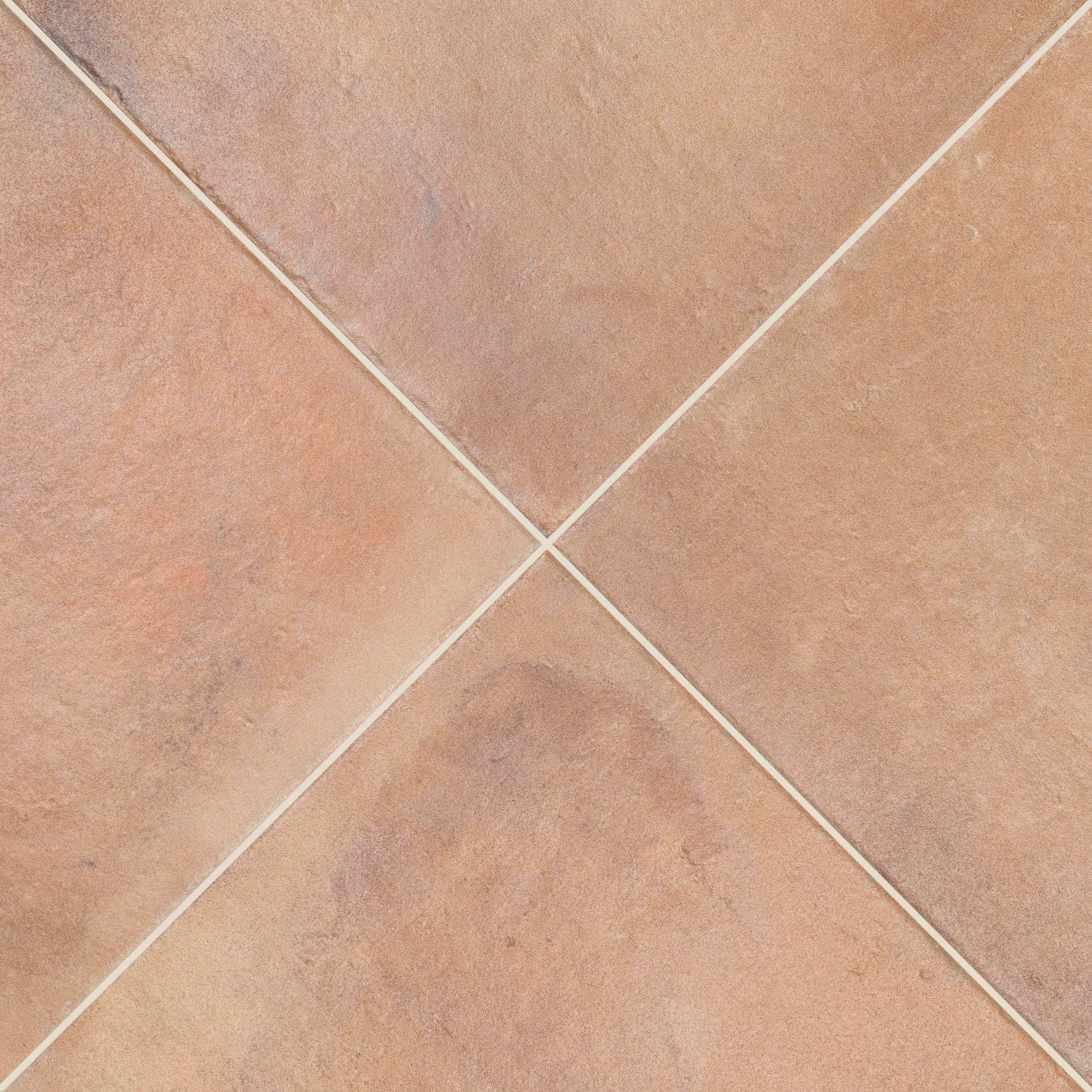 Close up of square terracotta tiles with pale grout lines forming a diagonal grid