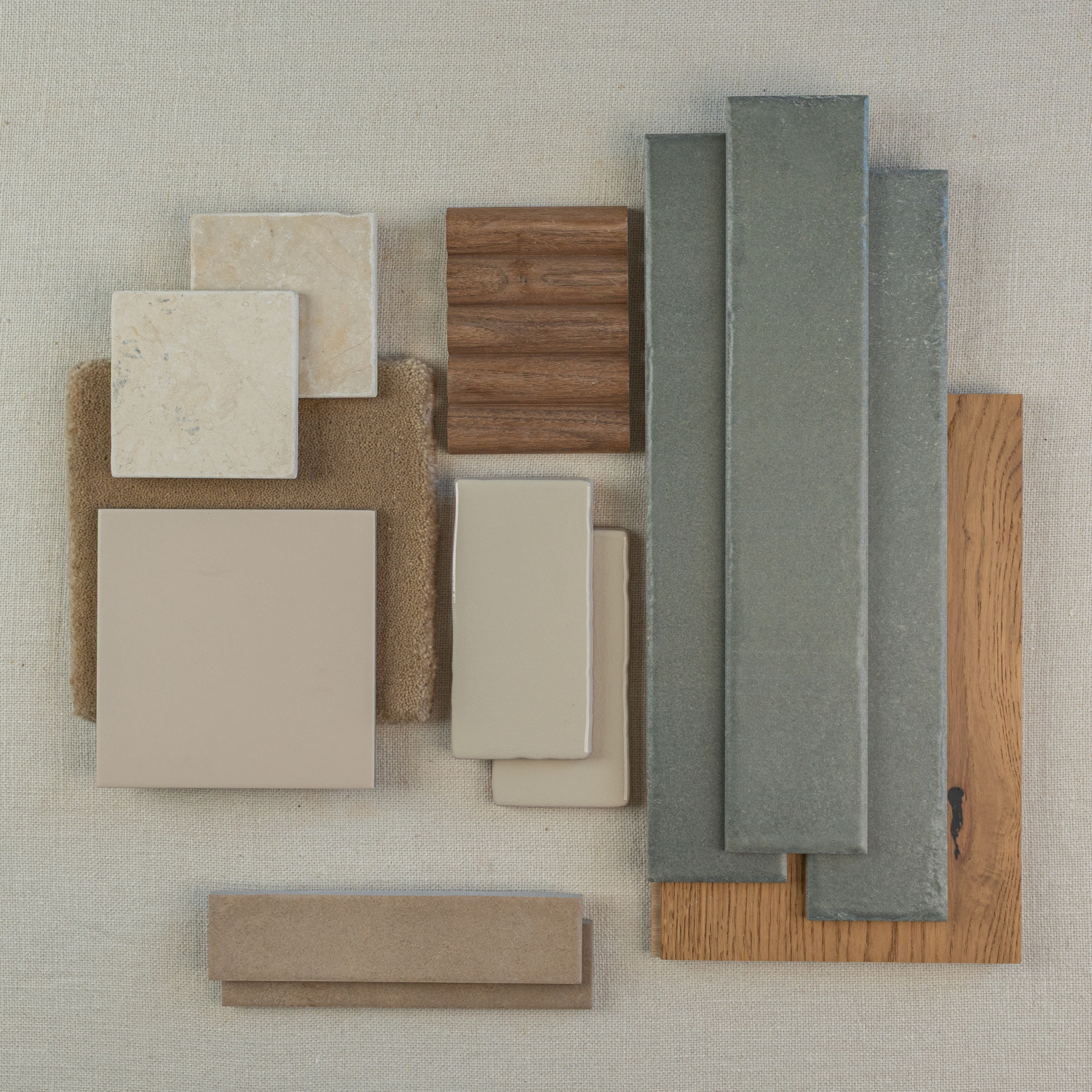 Top view of beige porcelain tiles, wood samples, long gray ceramic tiles, and neutral fabric swatches on light background