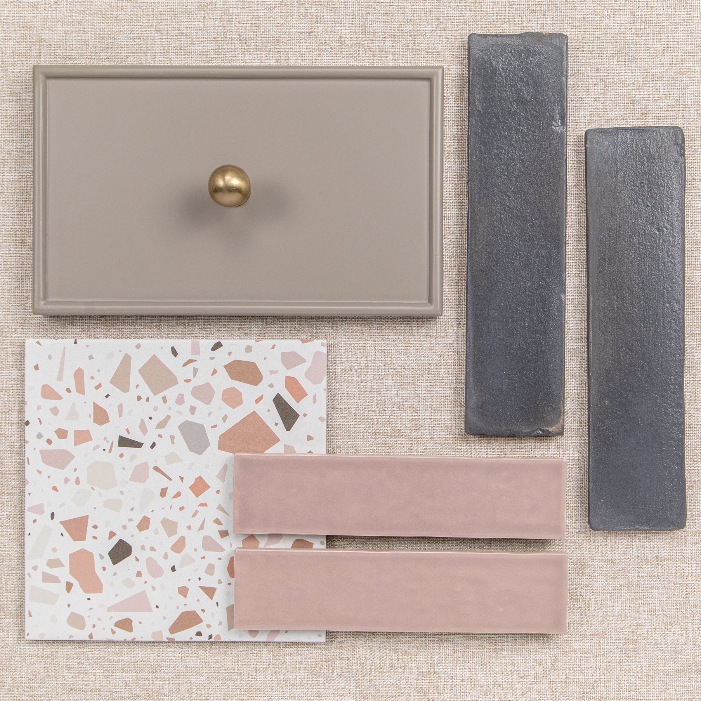 Assorted neutral tile samples including terrazzo, pink, taupe, and dark gray finishes