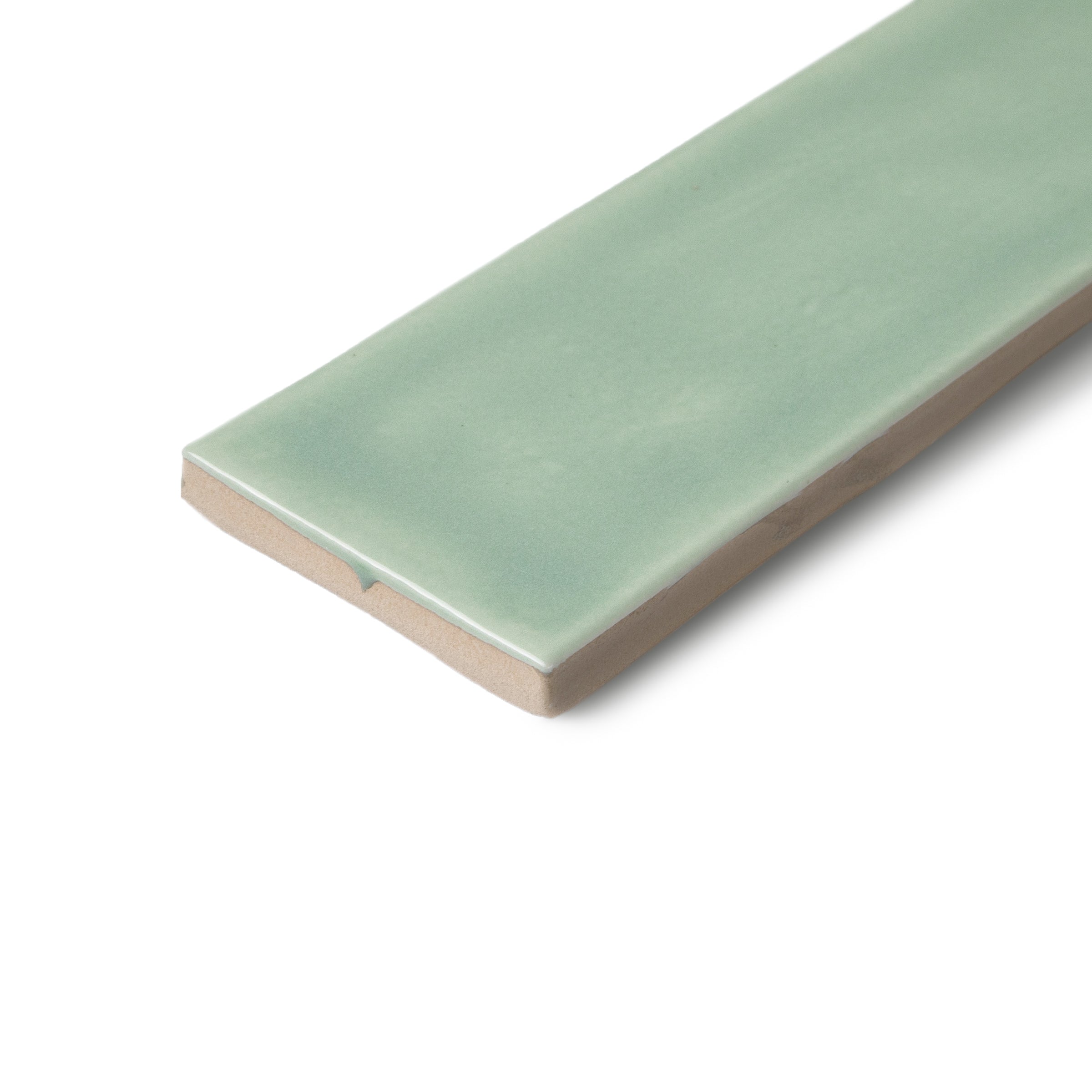 Green glazed ceramic tile with a rectangular shape and softly rounded edges on a white background