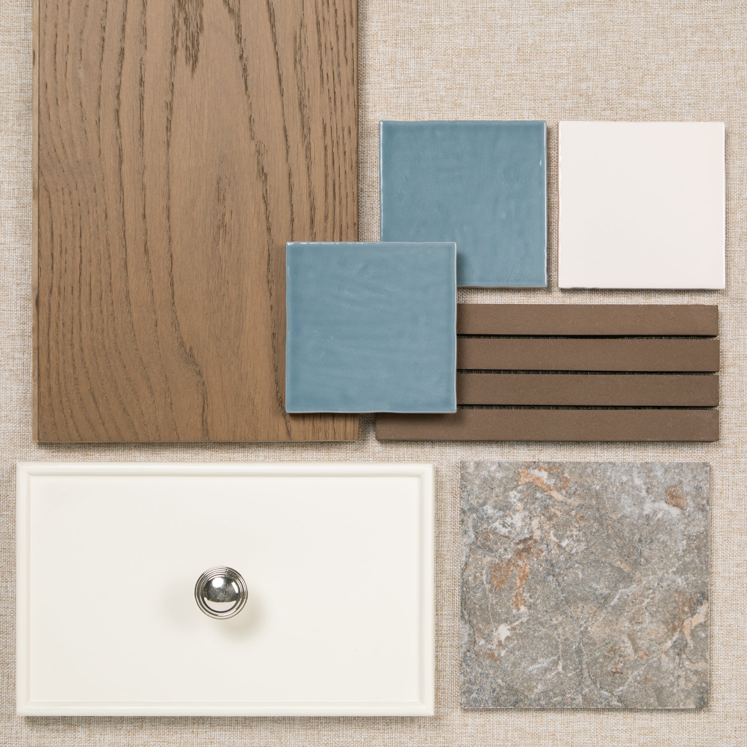 Interior material samples with oak wood, blue and white tiles, brown slats, a white basin, and stone tile 