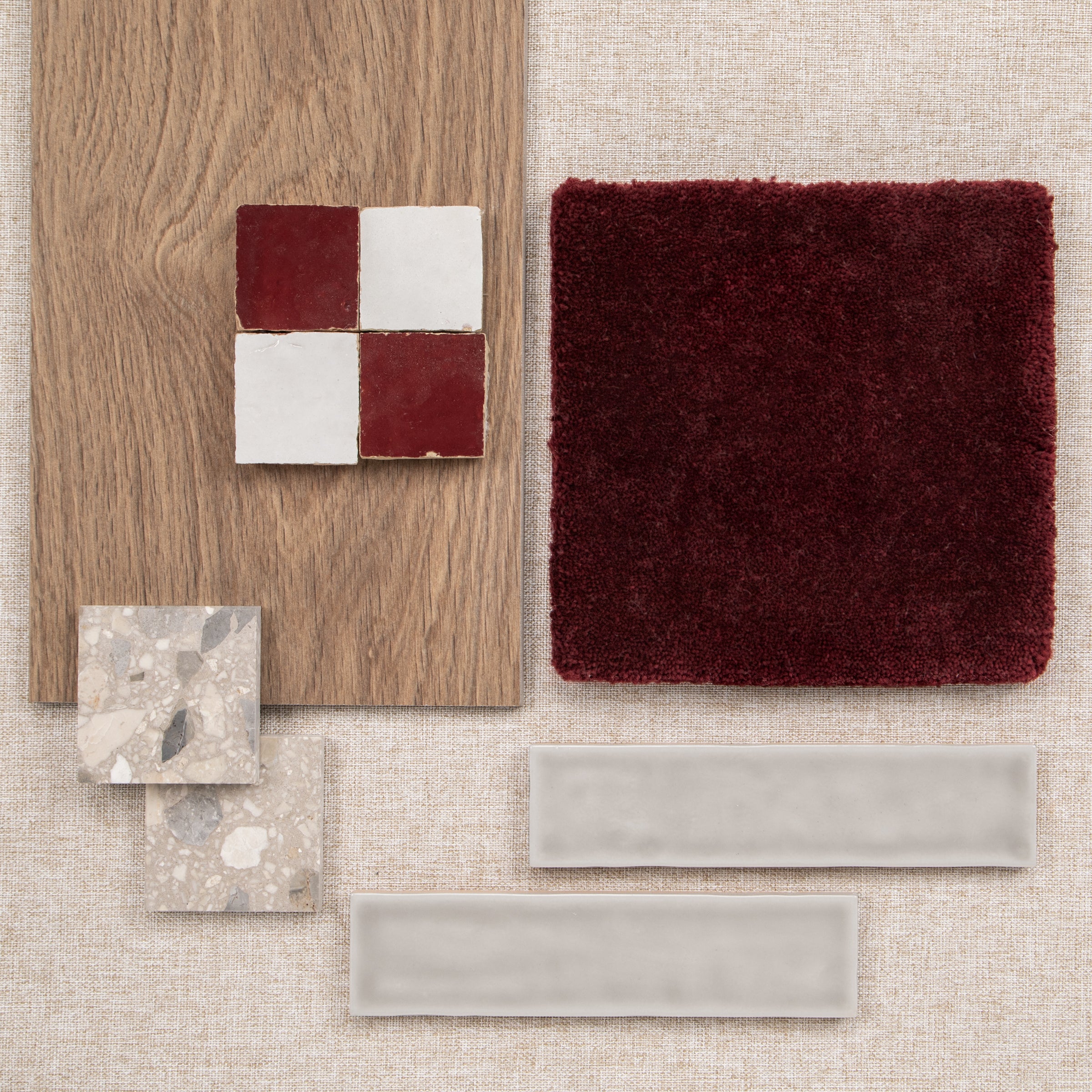 Material mood board with oak wood red and white tiles burgundy textile stone samples and white tile bars