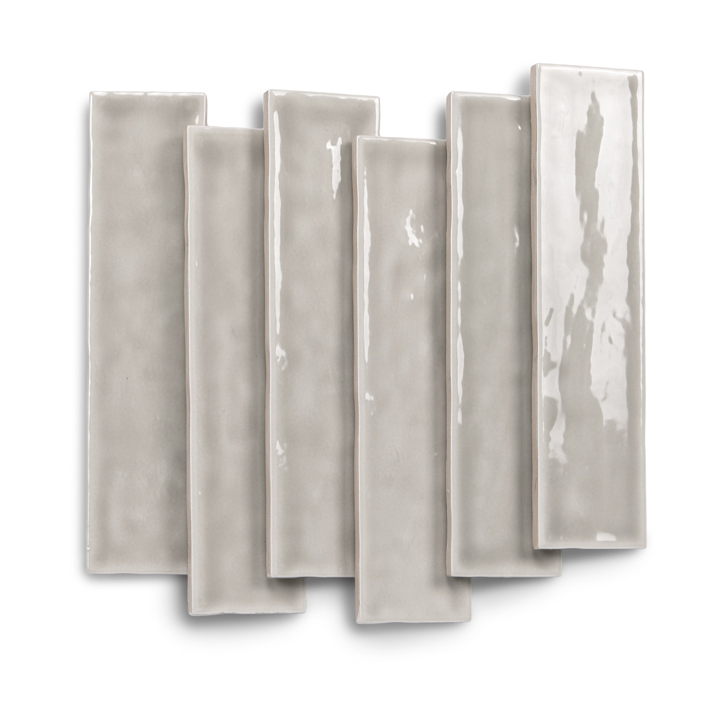 Pale gray glossy rectangular tiles with softly varied surfaces arranged in an overlapping display
