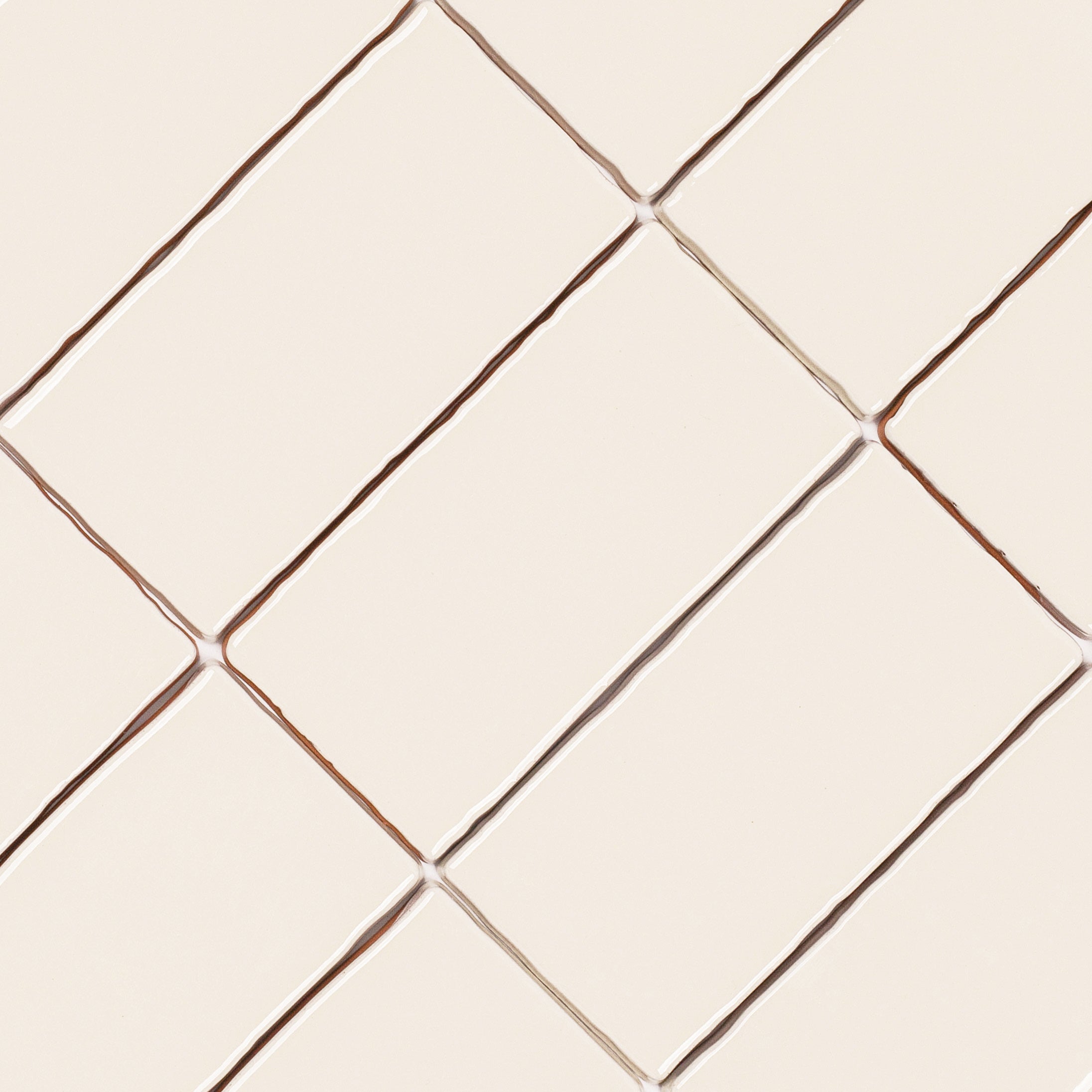 Dark White 3x6 Glossy Ceramic Tile in warm beige and white tones with a subtle undulating surface from Seville Small Format Tiles collection