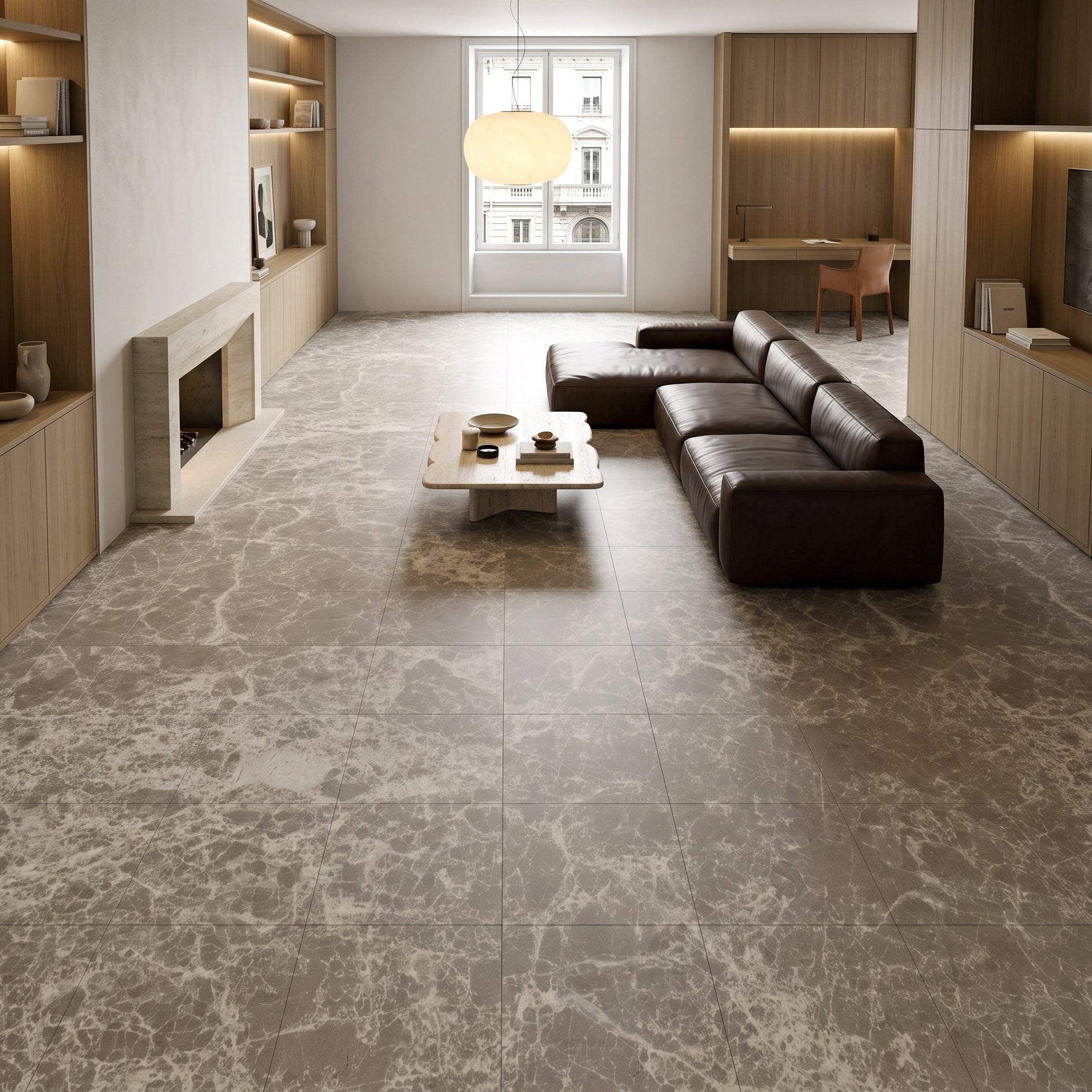 Spacious living room featuring large format marble-effect porcelain tiles, modern leather sectional, and built-in wood shelving.