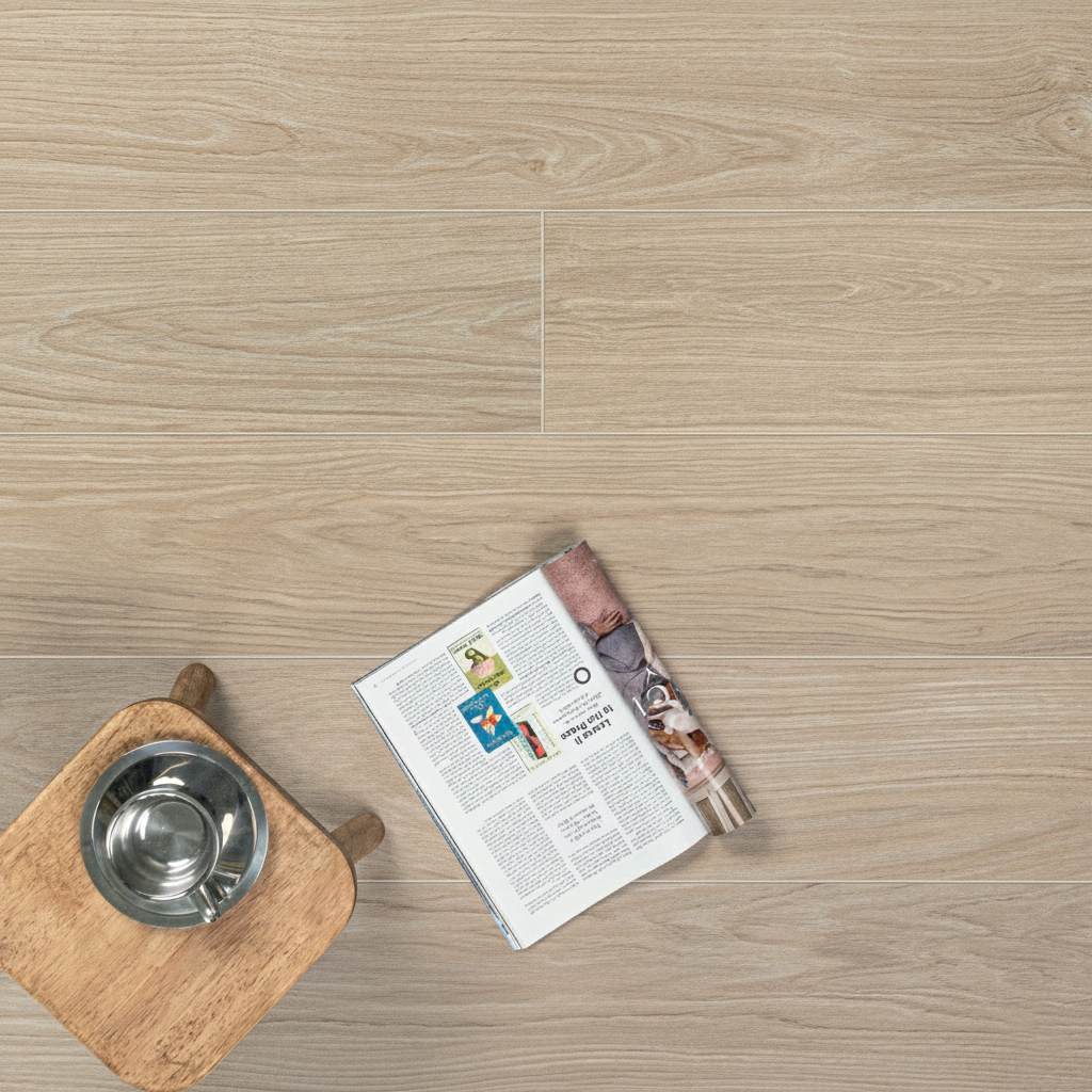 Light oak engineered wood flooring with subtle grain details and a wooden stool holding a metal bowl and an open magazine nearby