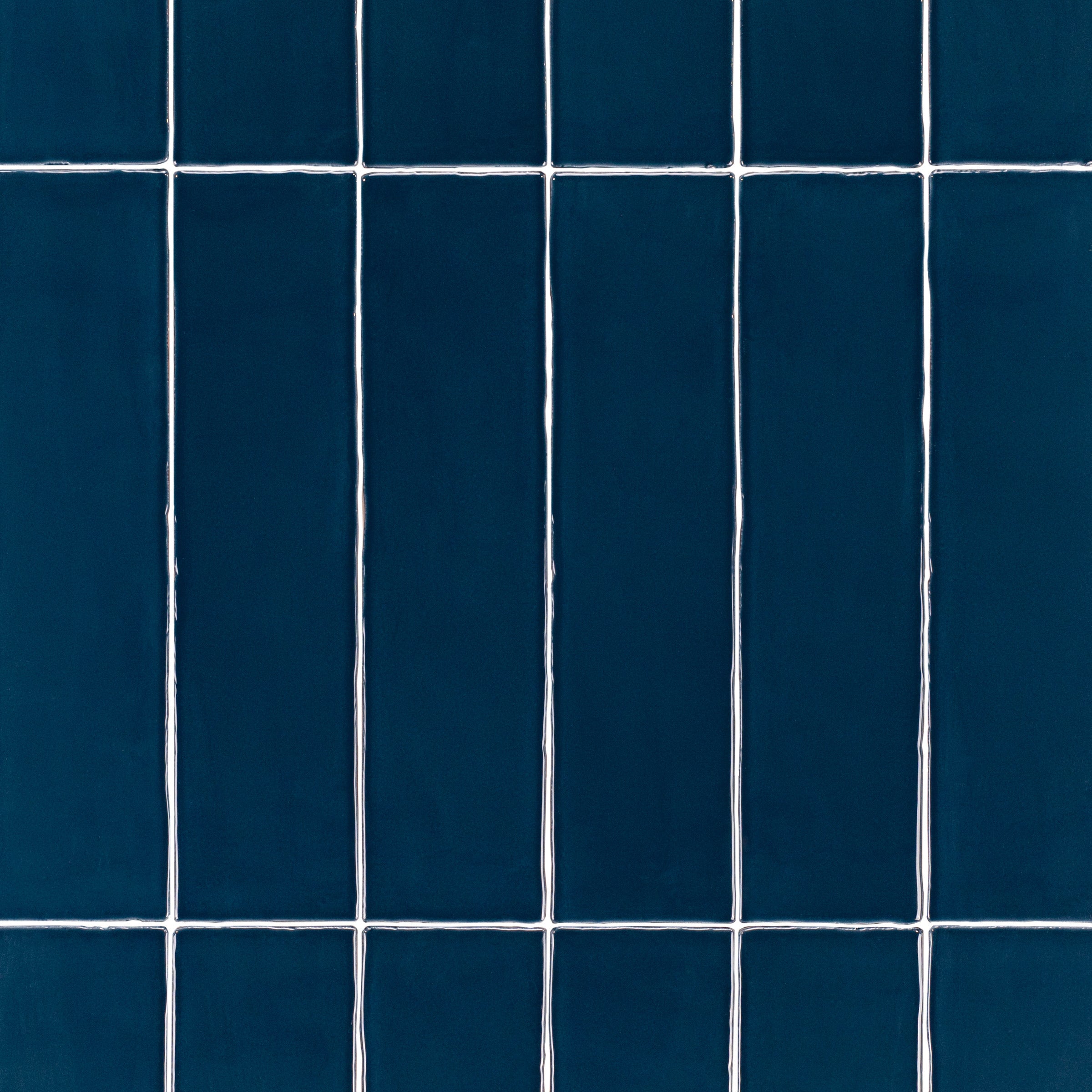Marine 3x12 Glossy Ceramic Tile in deep teal navy with a rich gloss and slightly irregular edges from Seville Glossy Ceramic Tiles