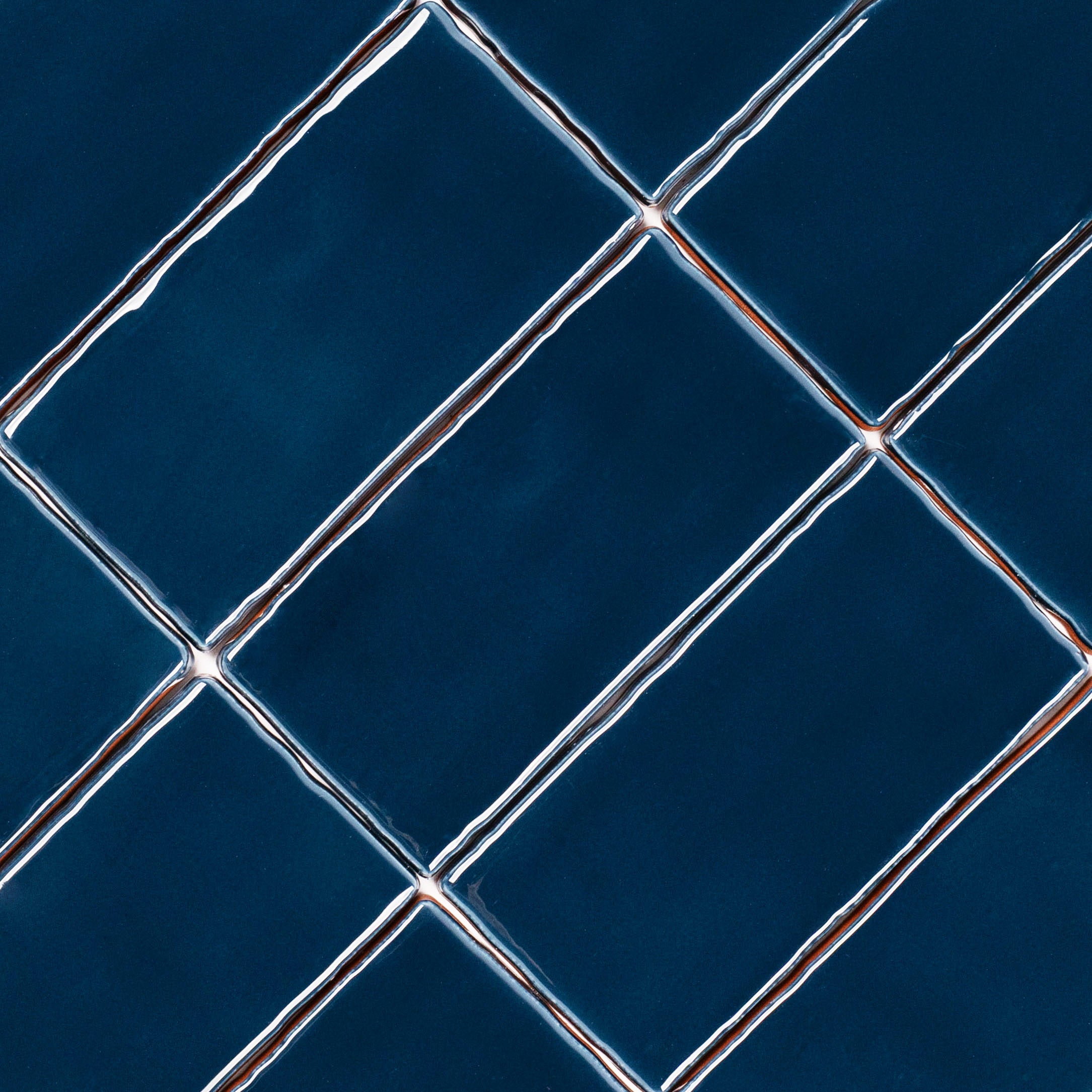 Marine 3x6 Glossy Ceramic Tile in deep blue with rich gloss and gently irregular edges from Seville Glossy Ceramic Tiles collection