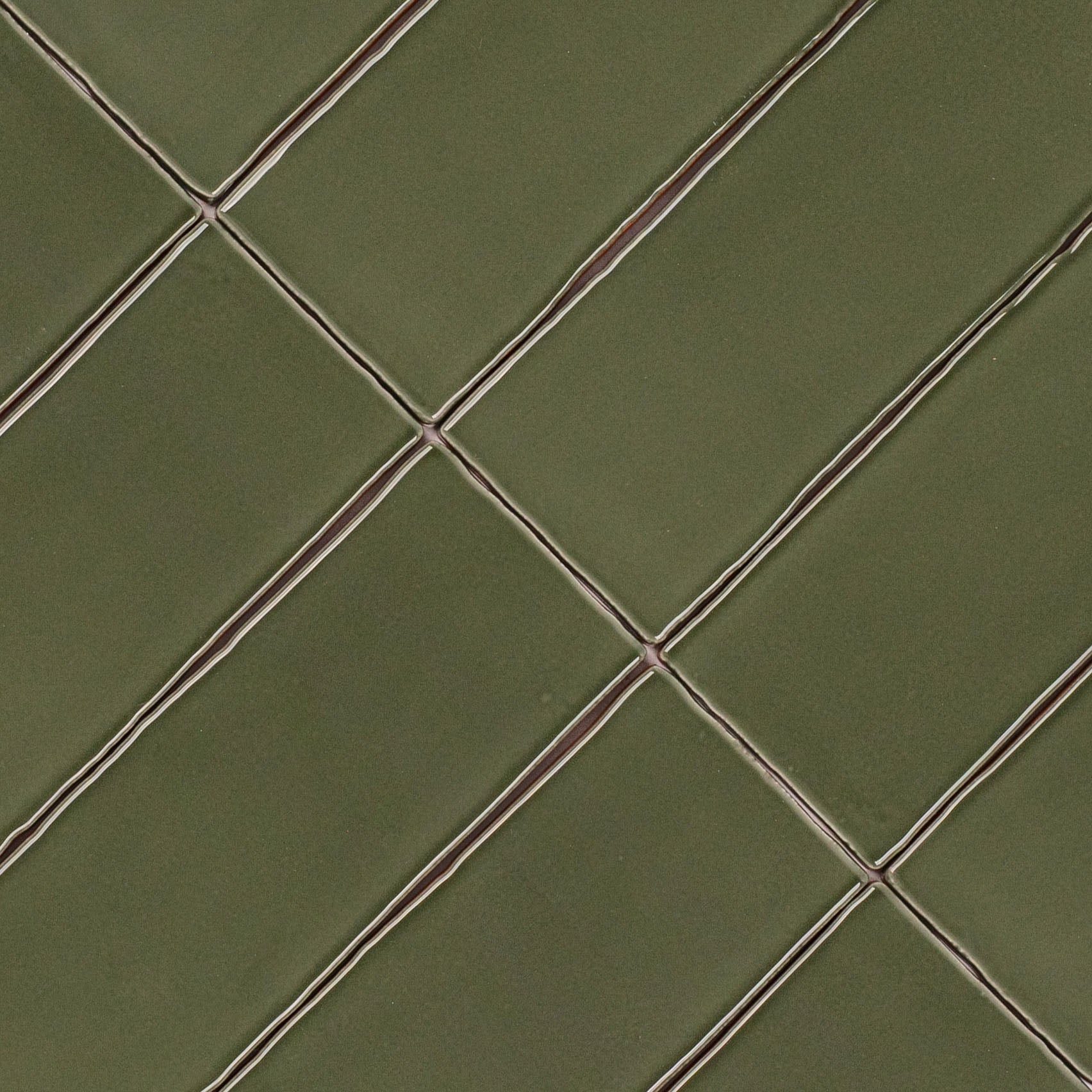 Olive 3x12 Glossy Ceramic Tile in deep muted green with rich gloss and gently irregular edges from Seville Glossy Ceramic Tiles collection