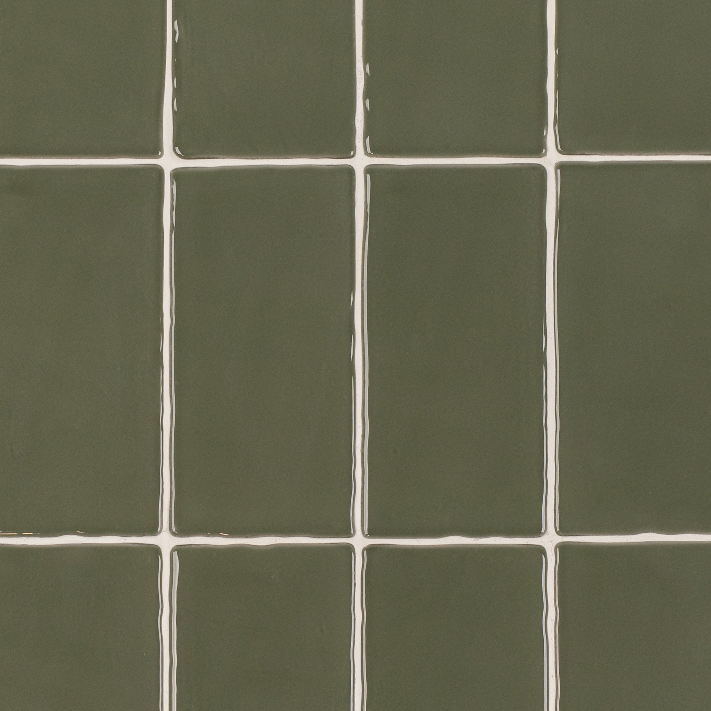 Olive 3x6 Glossy Ceramic Tile in deep muted green with a rich gloss and slightly irregular edges from Seville collection