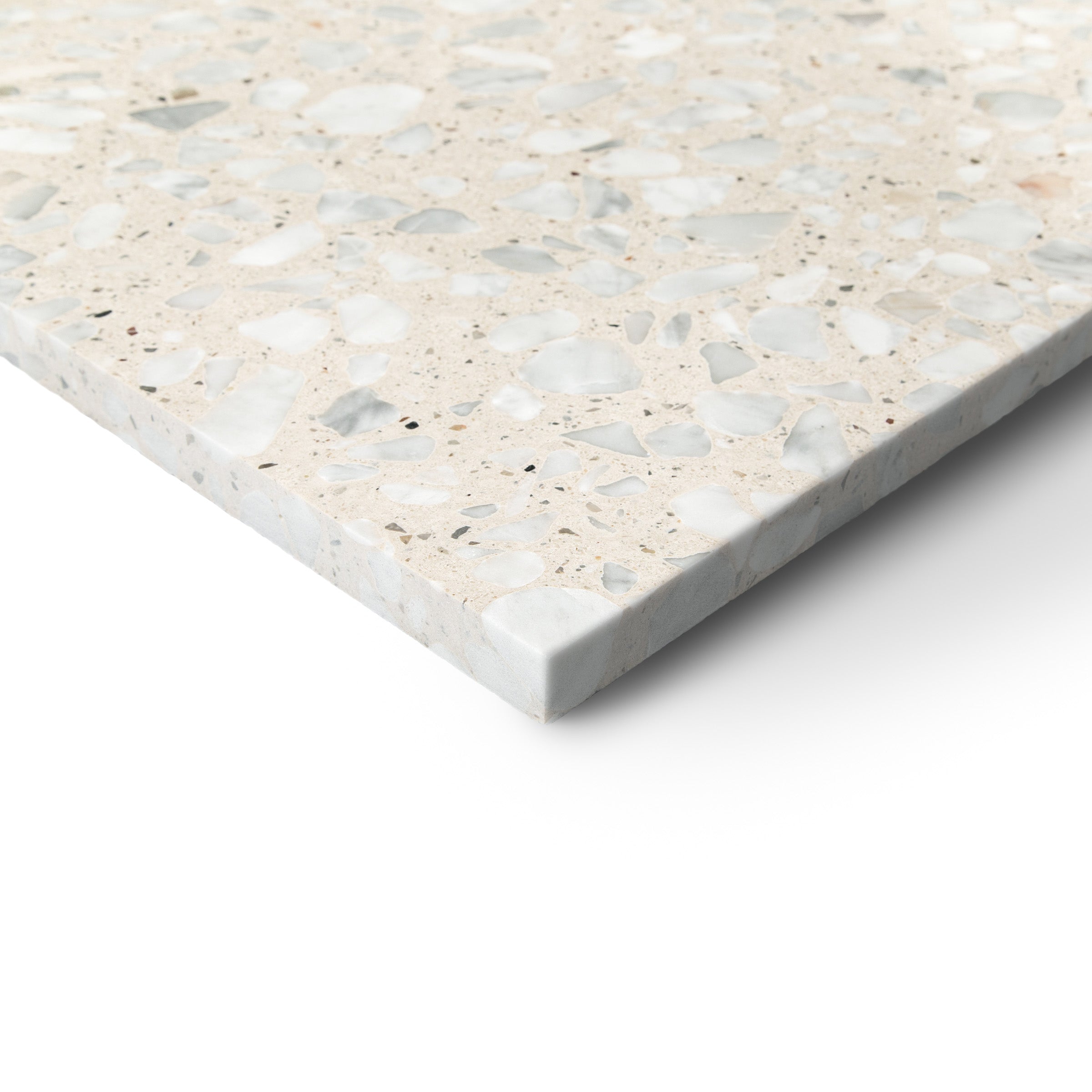 Close-up of a beige terrazzo tile with small stone chips embedded in a smooth surface on a white background