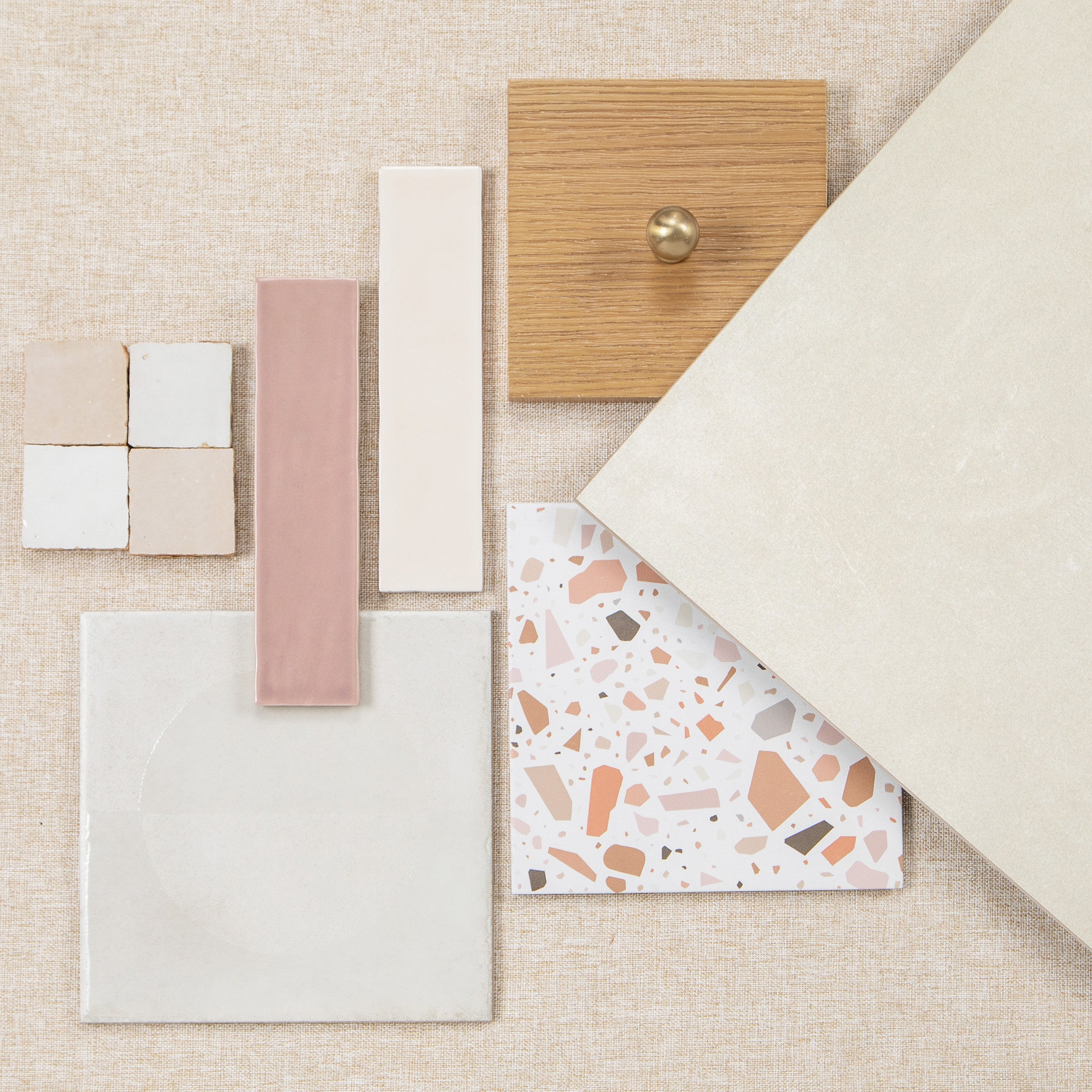 Tile and wood finish samples in neutral white, pink, terrazzo, and natural tones