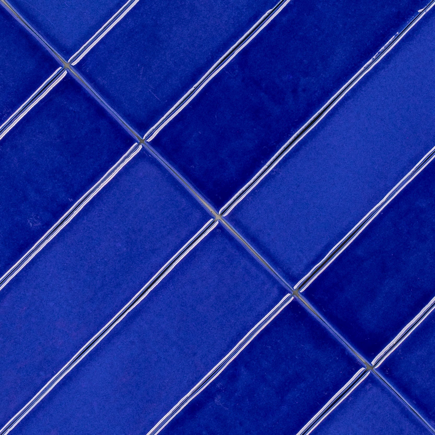 Sapphire Glossy Ceramic Tile in vibrant blue with handcrafted Moroccan zellige inspired pattern from Small Format Tiles collection
