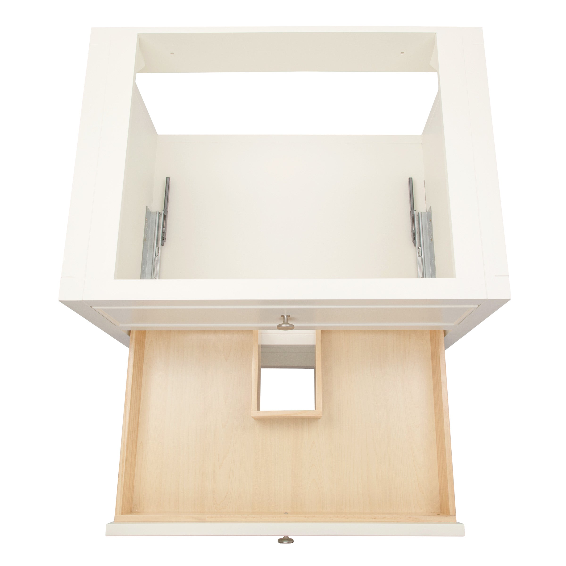 Top-down view of an open white drawer with light wood interior and a central cutout inside a white cabinet frame