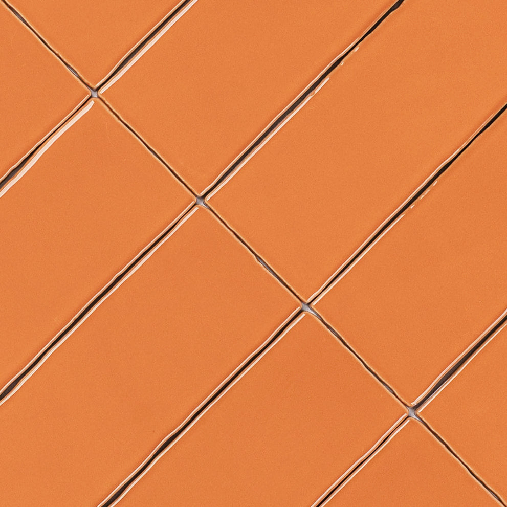Terracotta 3x12 Glossy Ceramic Tile in warm orange with vibrant gloss and slightly irregular edges from Seville Glossy Ceramic Tiles