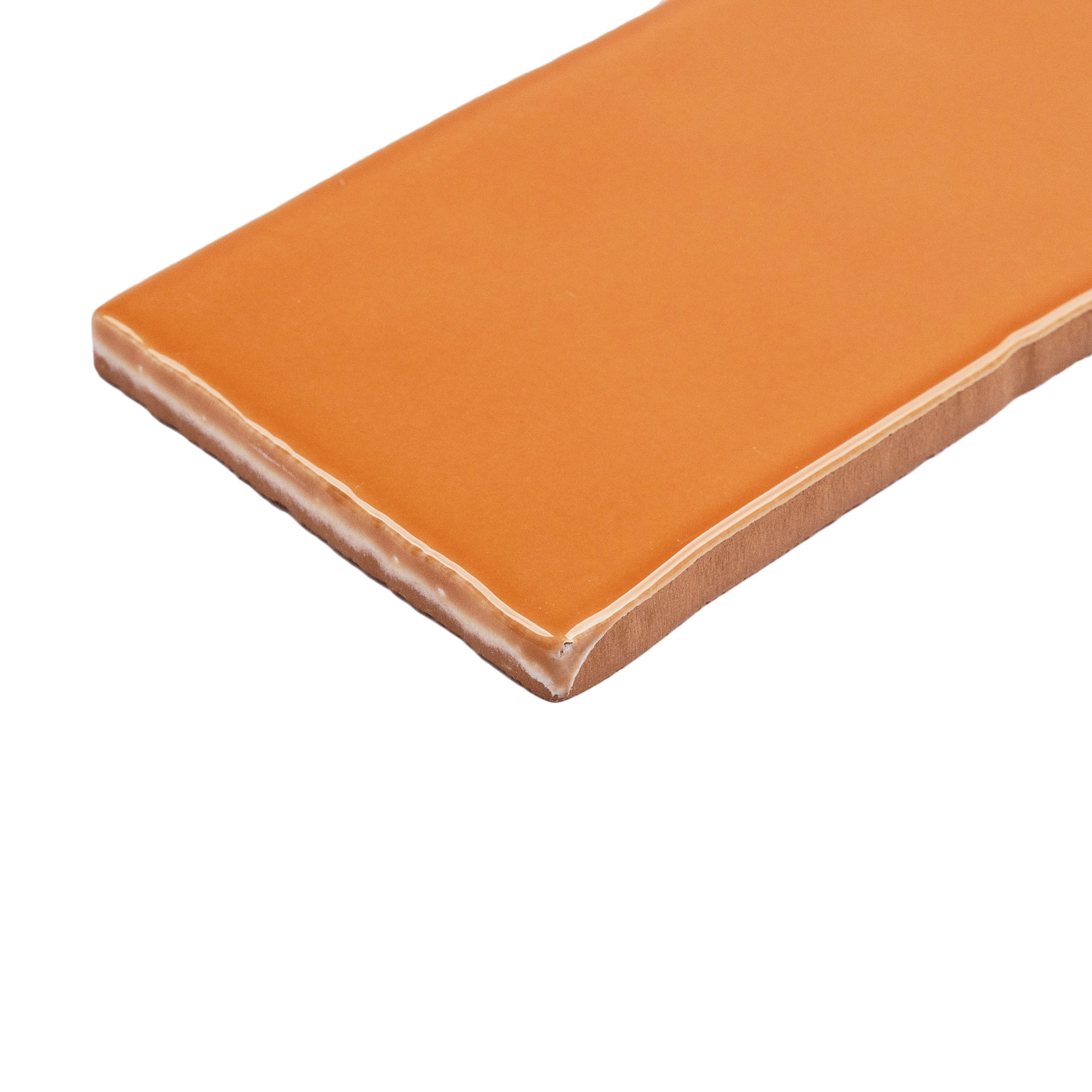 Terracotta 3x12 Glossy Ceramic Tile in warm burnt orange with a vibrant gloss and slightly irregular edges from Seville collection