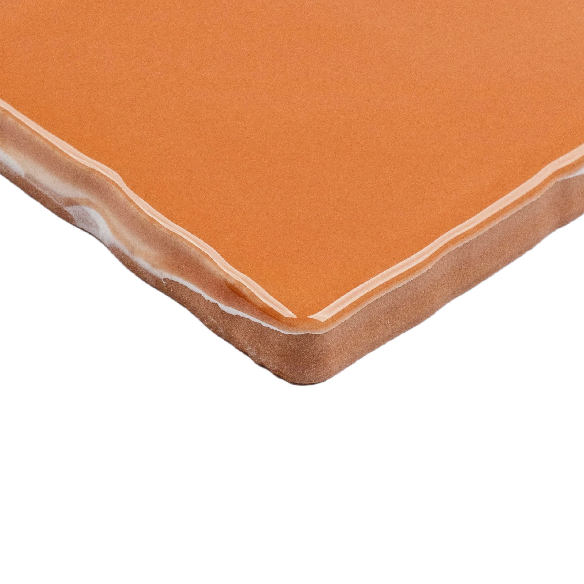 Terracotta 3x6 Glossy Ceramic Tile in warm burnt orange with a vibrant gloss and slightly handmade textured edges from Seville collection