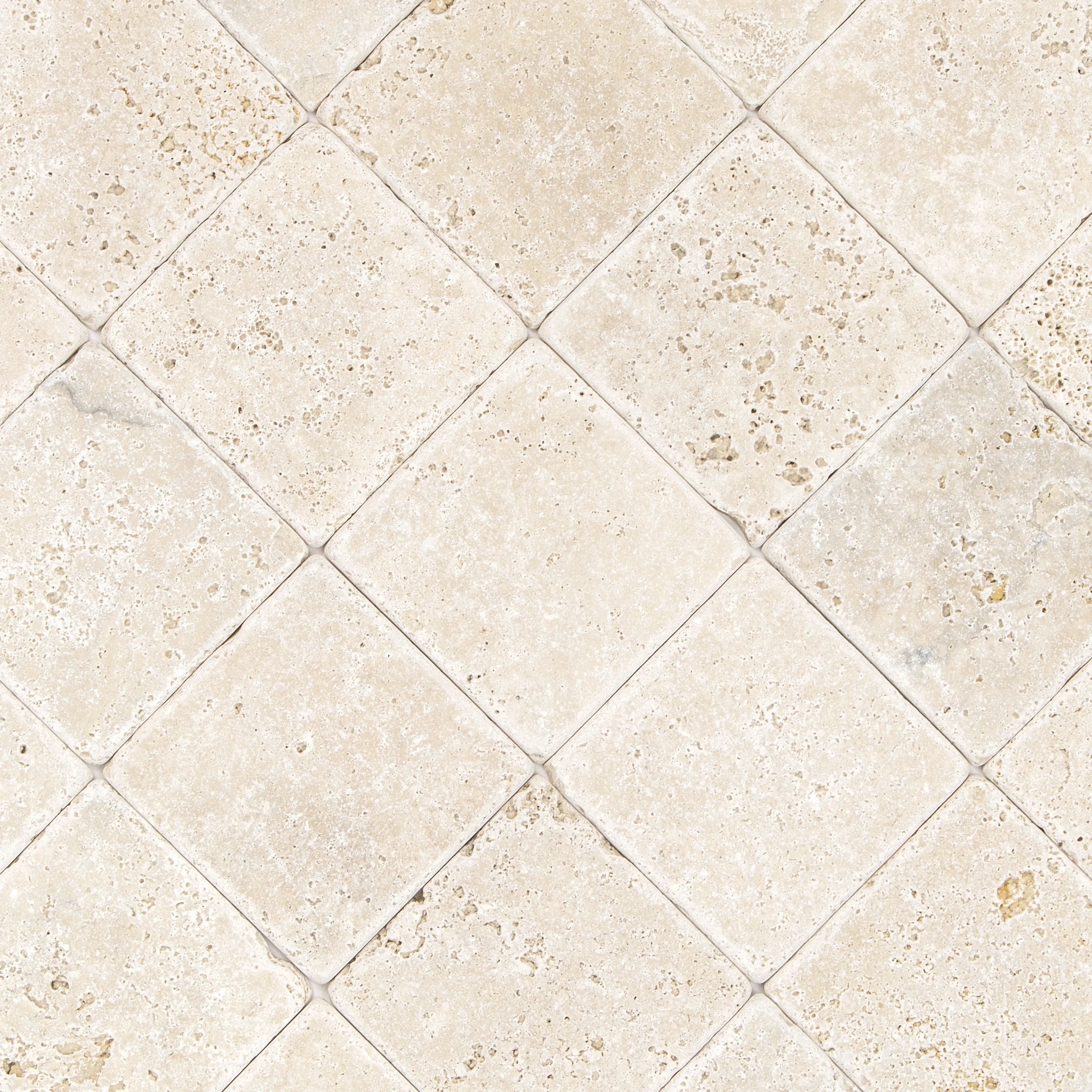 Beige travertine tiles with a tumbled finish, displaying natural stone texture and subtle color variations in a diagonal layout