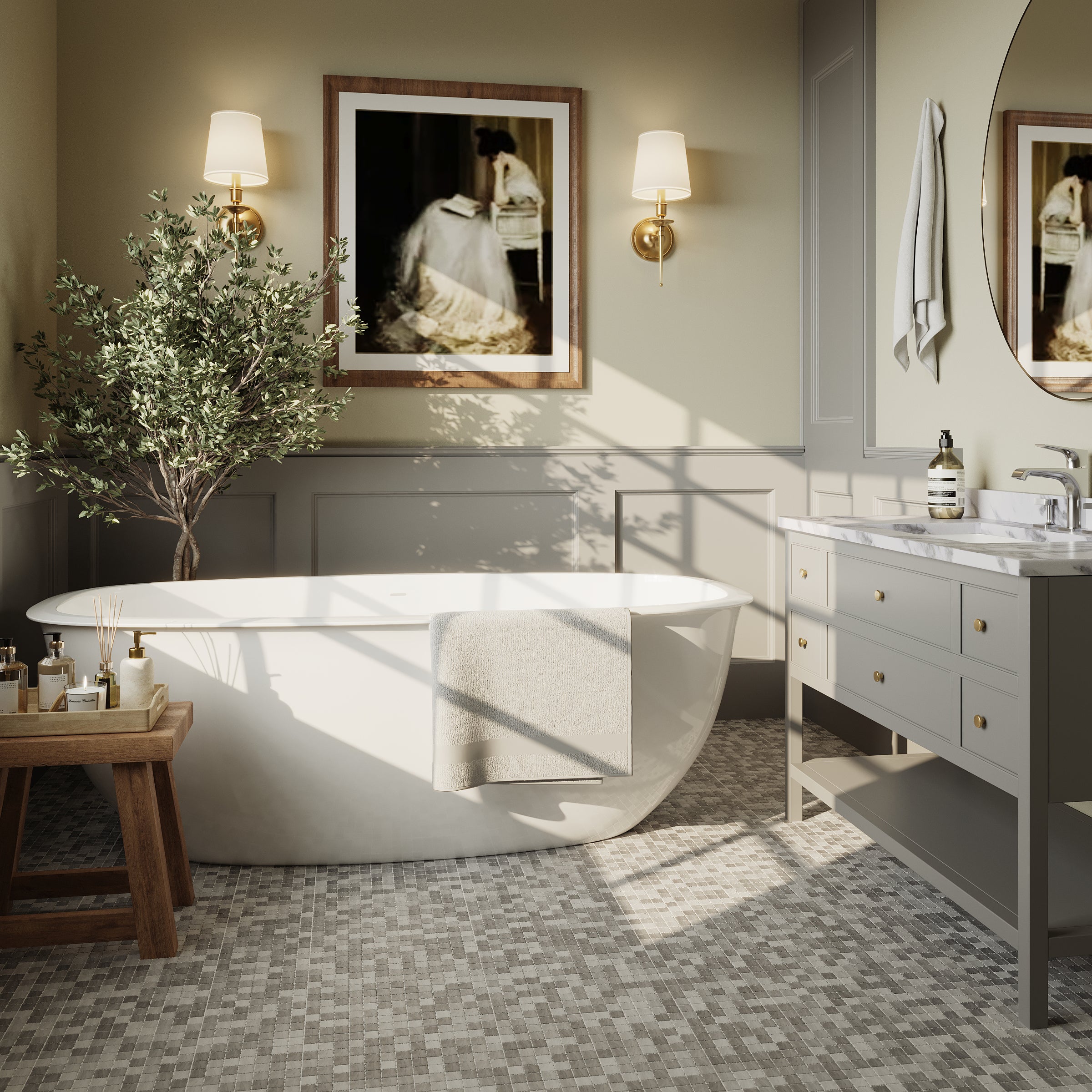 Bright bathroom with freestanding tub, mosaic floor tiles in taupe tones, gray vanity, brass wall sconces, and framed artwork.
