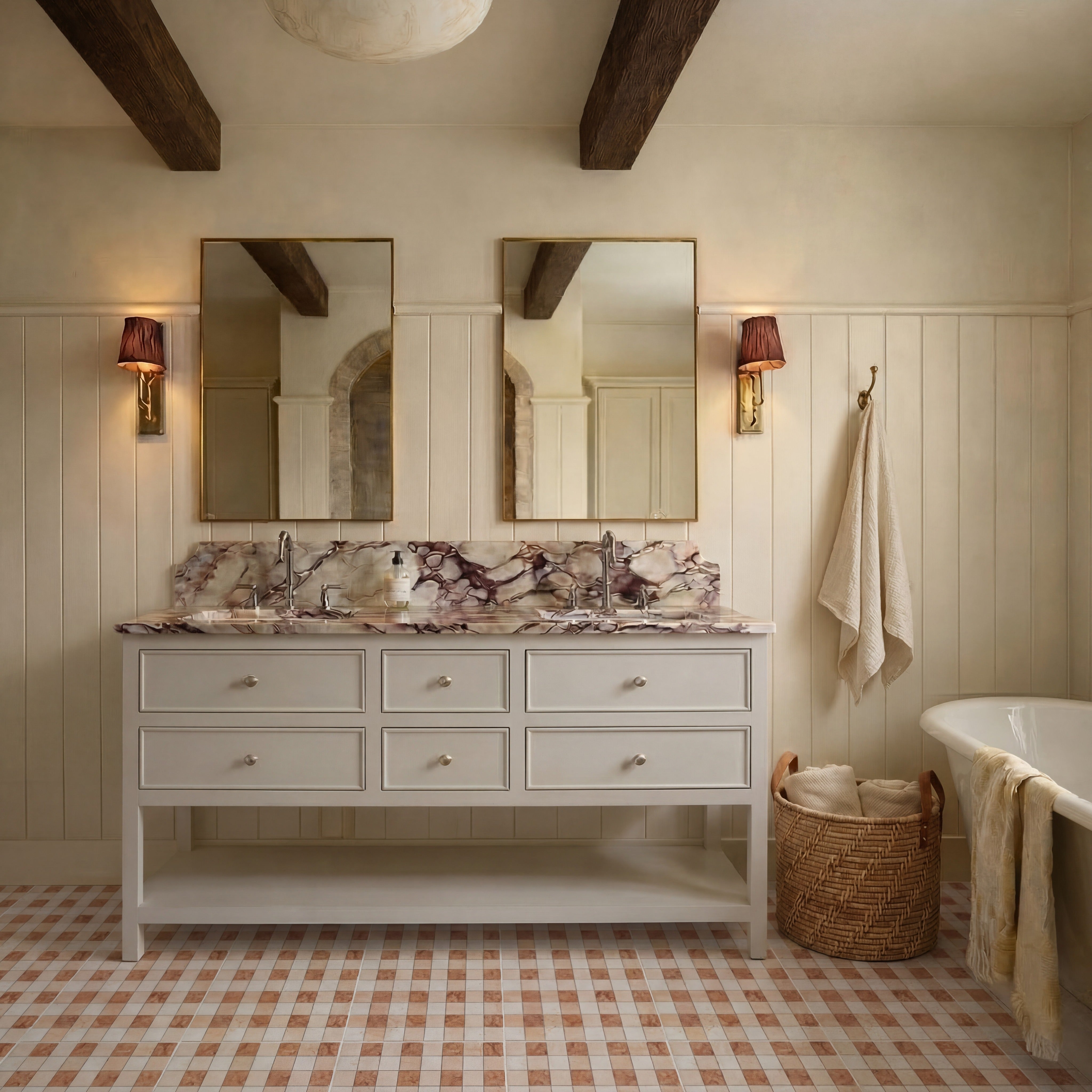 Bathroom with double sinks featuring marbled countertops, beige vanity, brass-framed mirrors, wooden beams, and checkered tile floor.