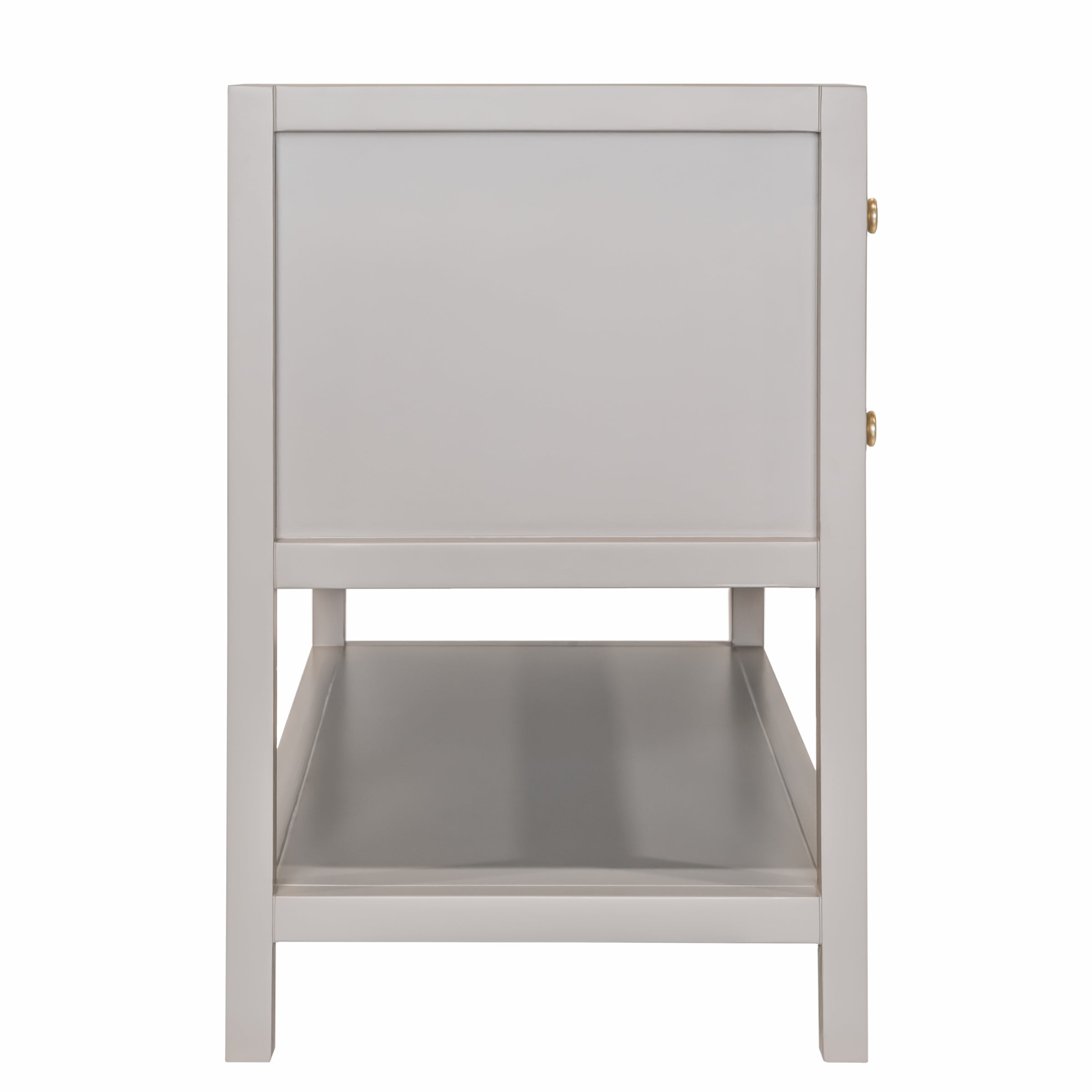 Side perspective of a taupe-colored wooden vanity with a lower open shelf and brass hardware accents