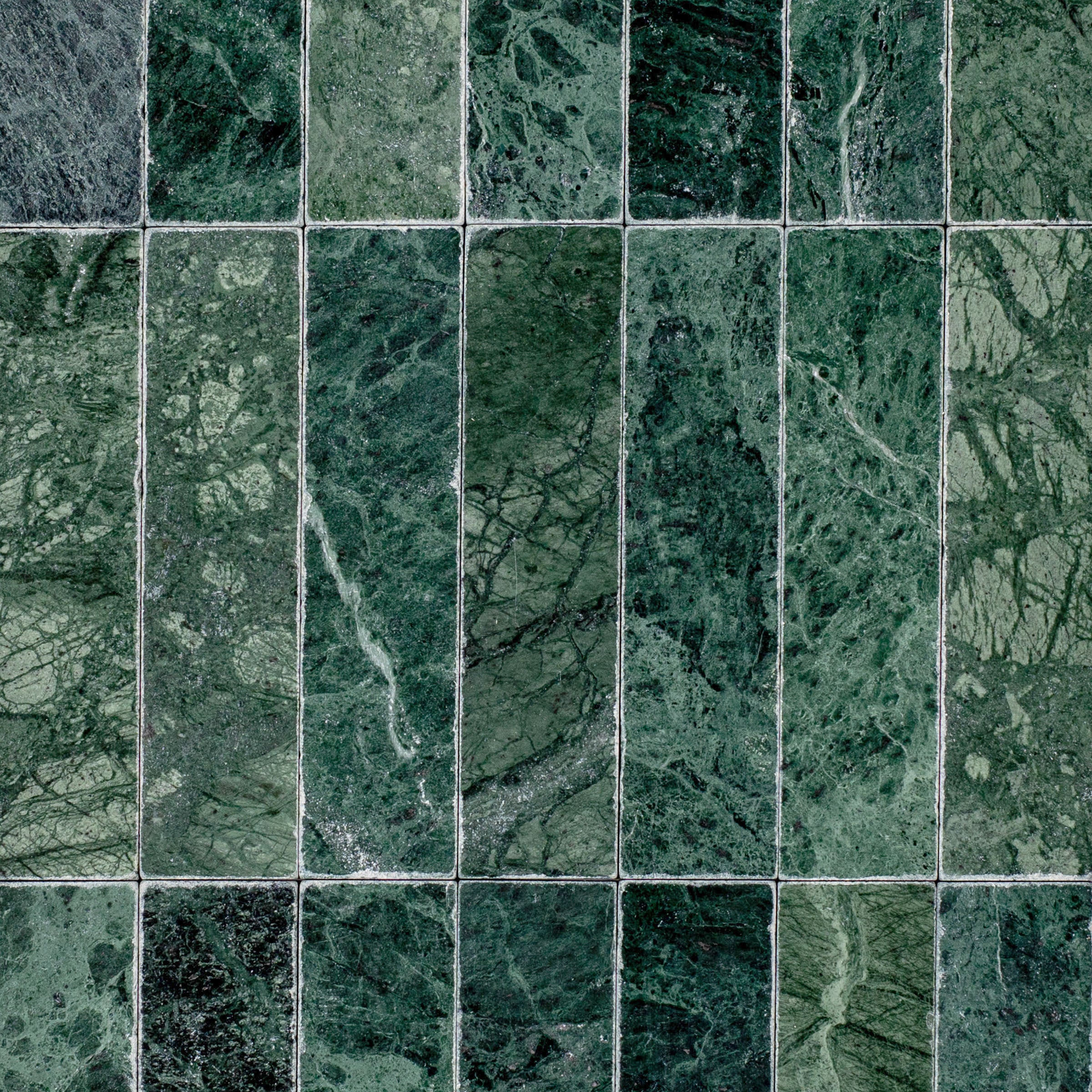 Verde Guatemala 2x8 Tumbled Marble Tile in green with bold white veining from Tumbled Natural Stone Tiles Stone New Arrivals Best Sellers