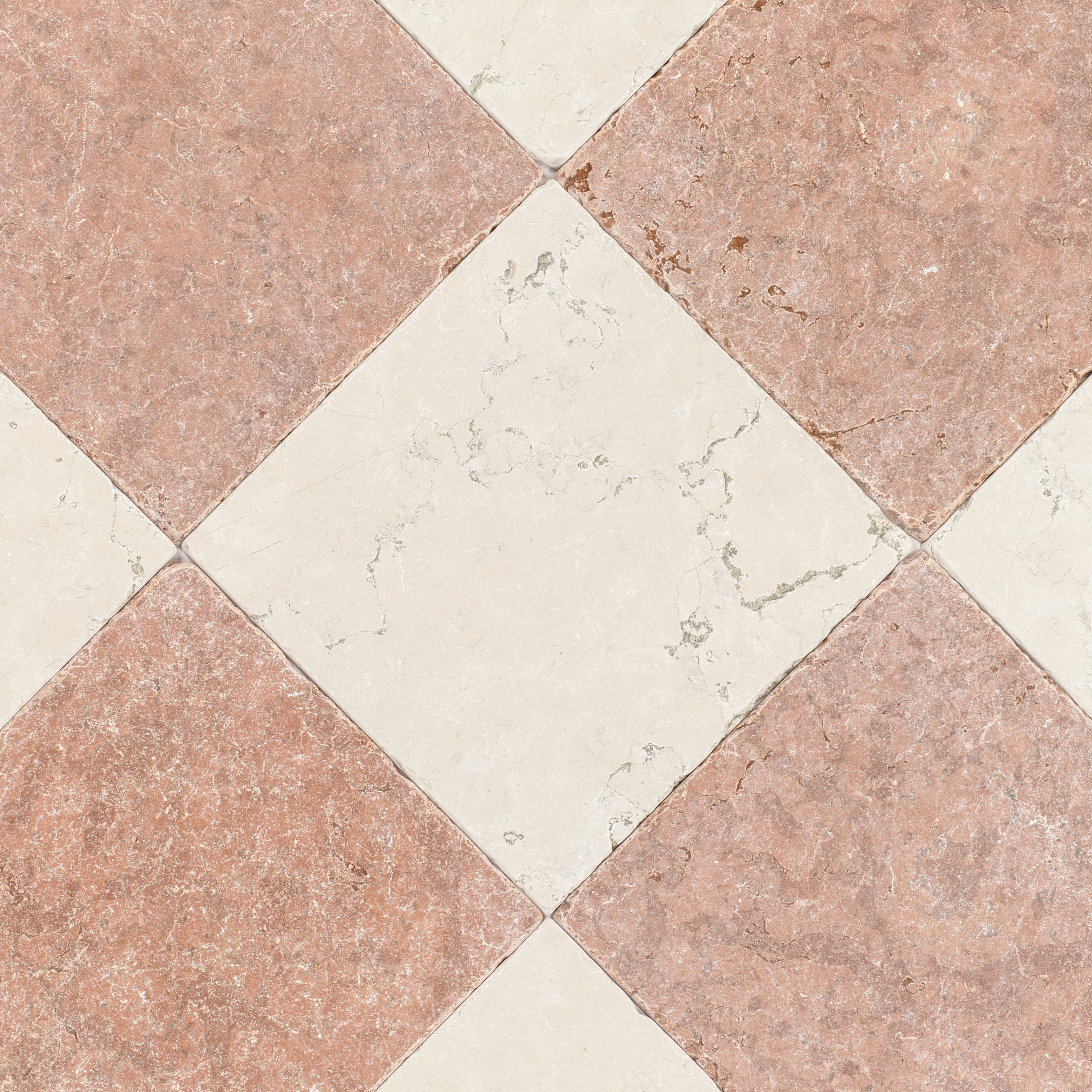 Close-up of rustic ceramic tiles with a weathered terracotta and light cream marble pattern in a diagonal checkerboard layout