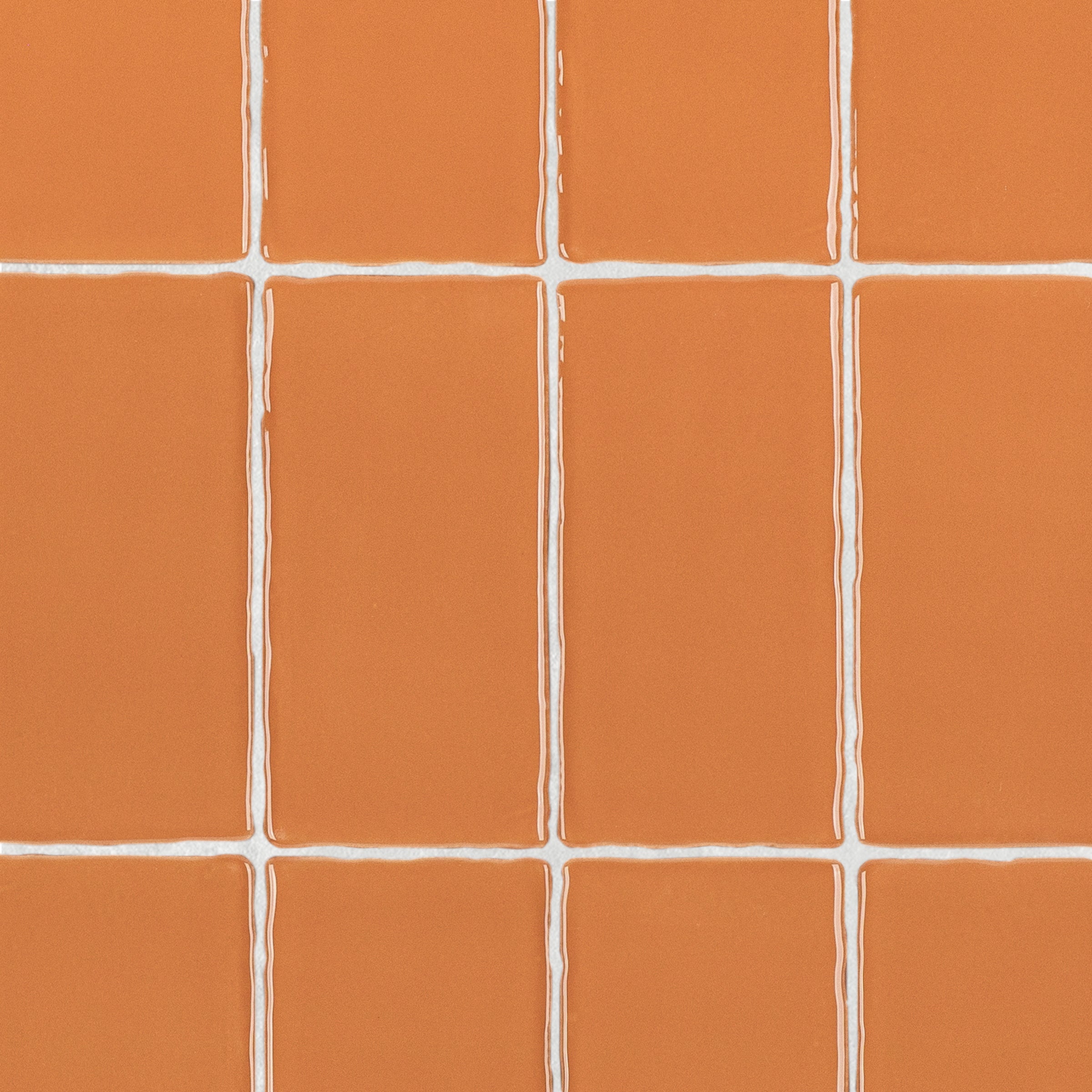 Terracotta 3x6 Glossy Ceramic Tile in warm burnt orange with a gloss finish and subtly irregular edges from Seville collection