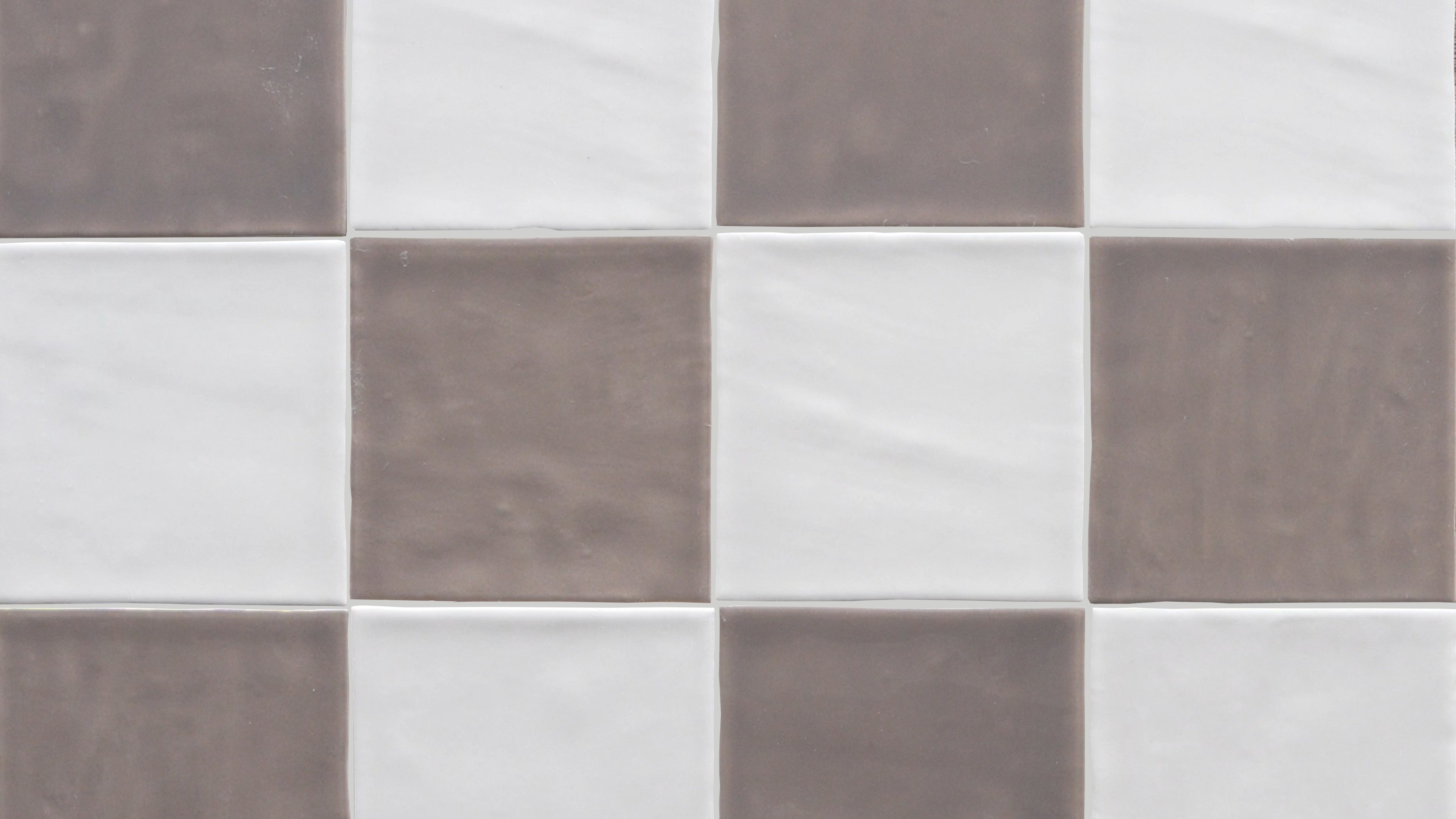 Checkerboard pattern of smooth ceramic tiles alternating between muted taupe and soft white shades with subtle texture variations