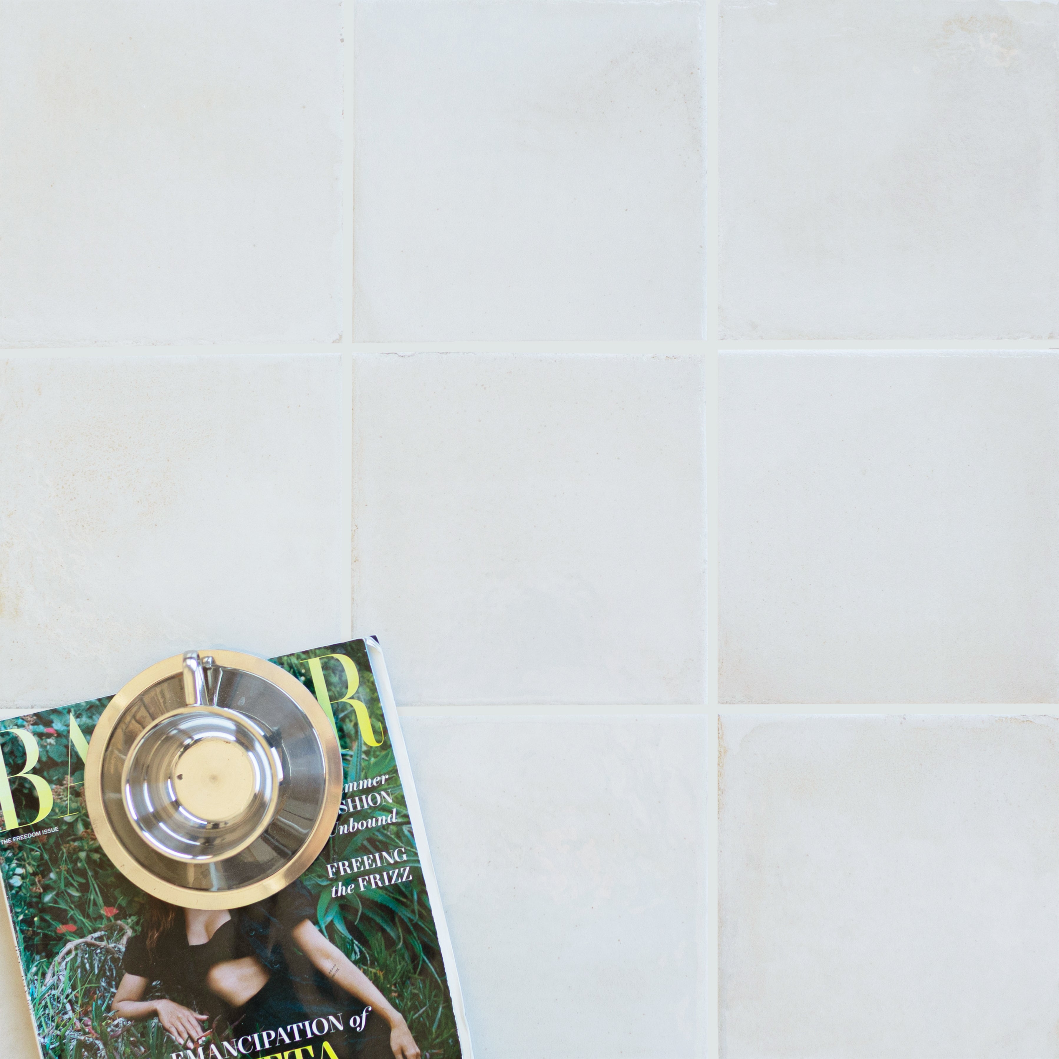 Soft matte porcelain tiles in light neutral shades with subtle natural textures arranged in a grid pattern