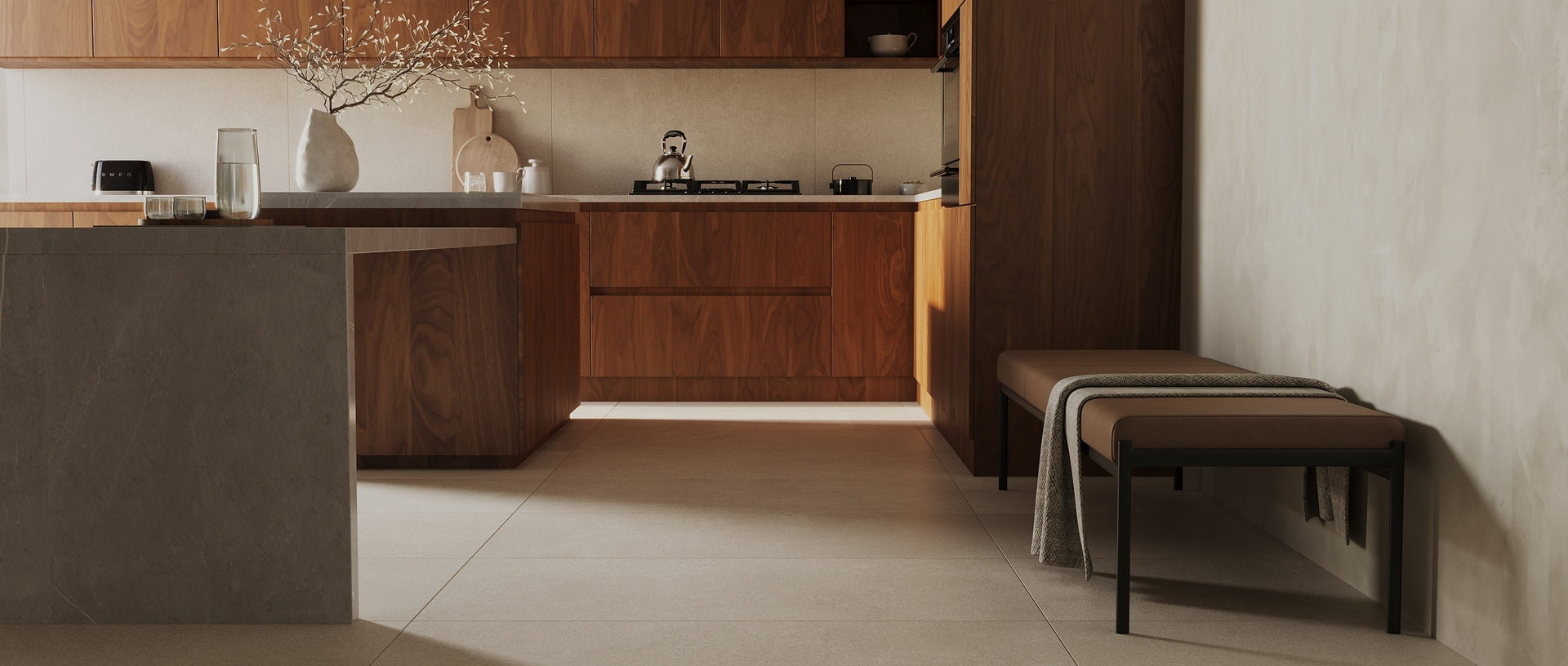 Modern kitchen with dark wood cabinetry, a stone island, stools, and large format floor tiles
