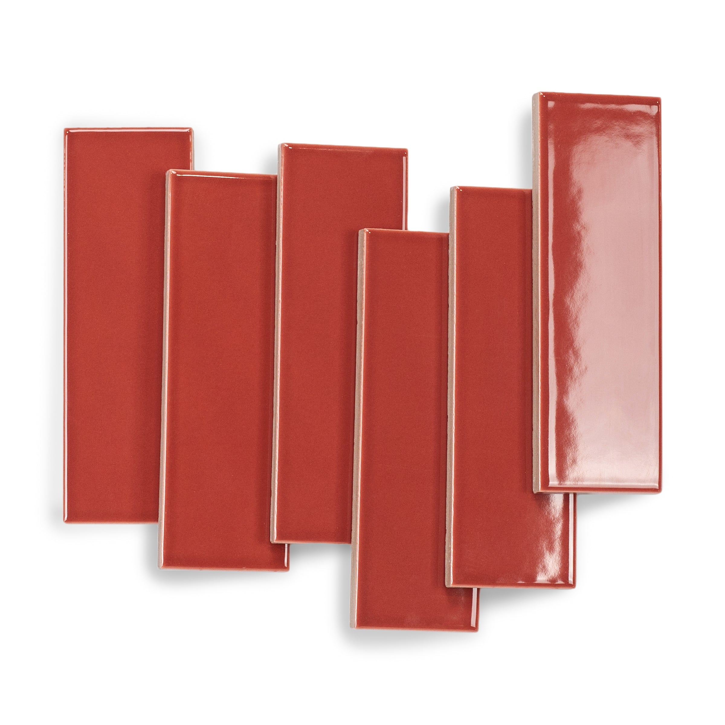 Glossy rectangular porcelain tiles in bold red with smooth surfaces and subtle reflective sheen arranged overlapping on white background