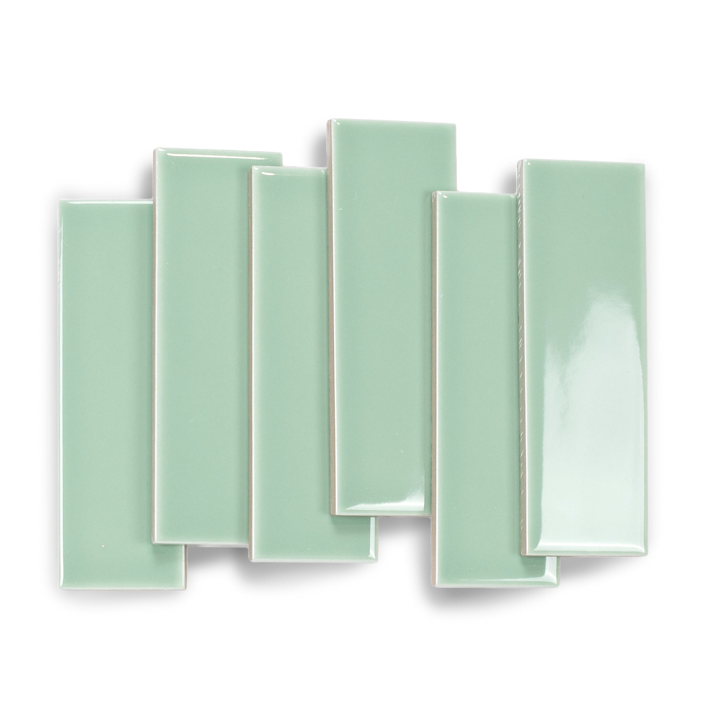 Glossy mint green rectangular porcelain tiles with smooth surfaces arranged in overlapping pattern on white background