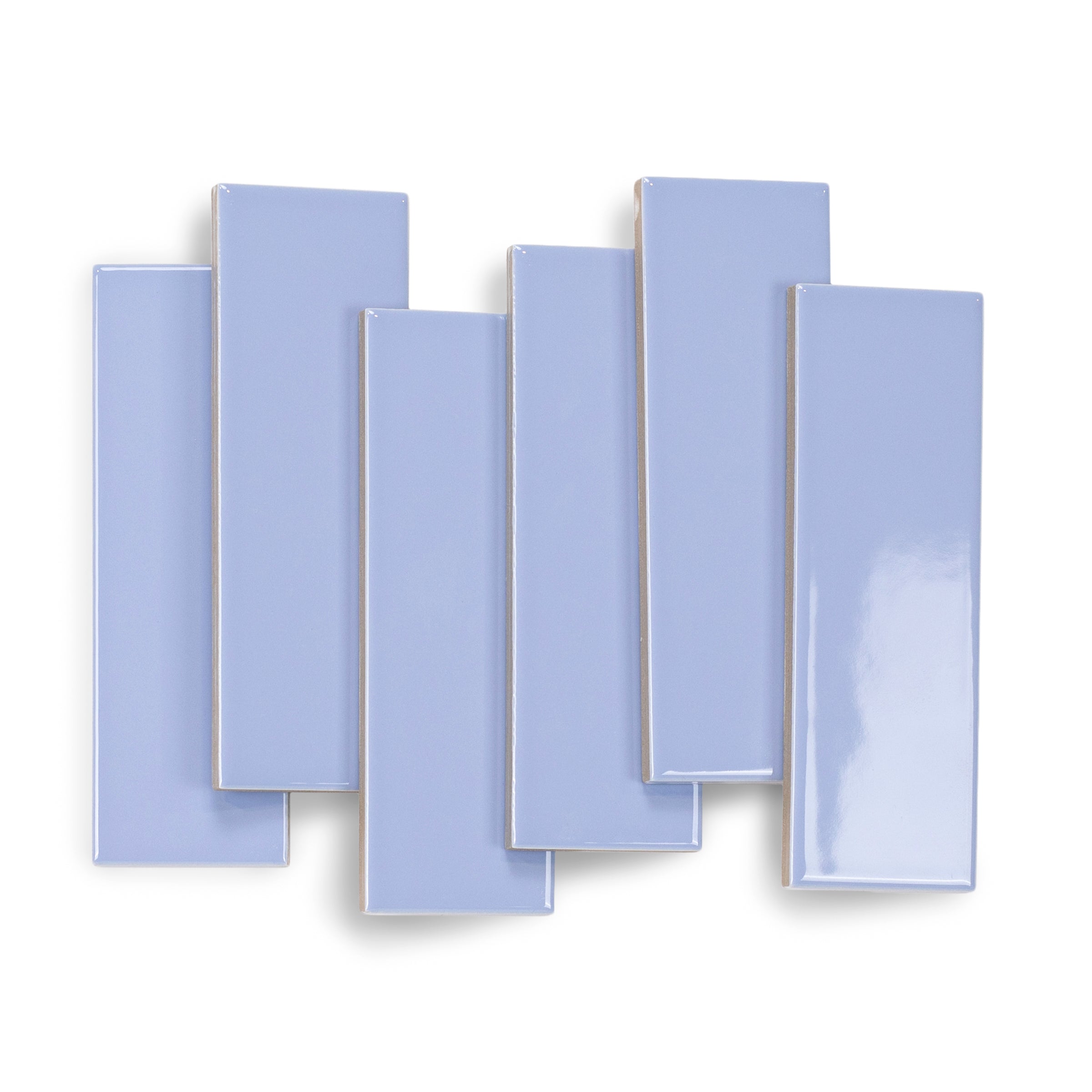 Glossy slim rectangular ceramic tiles in soft periwinkle blue with smooth surfaces arranged overlapping on white background