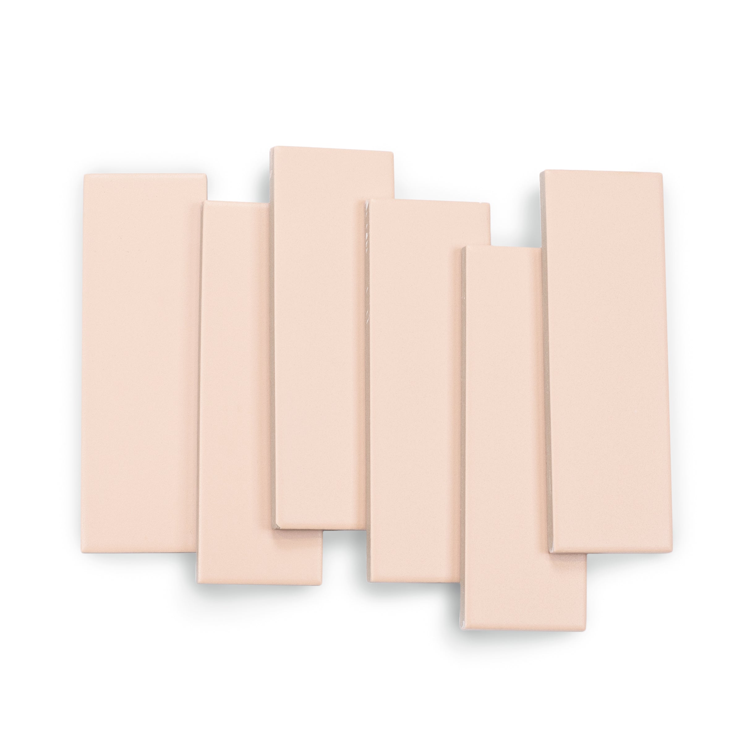 Matte rectangular porcelain tiles in a soft peach tone with smooth surfaces arranged in an overlapping pattern