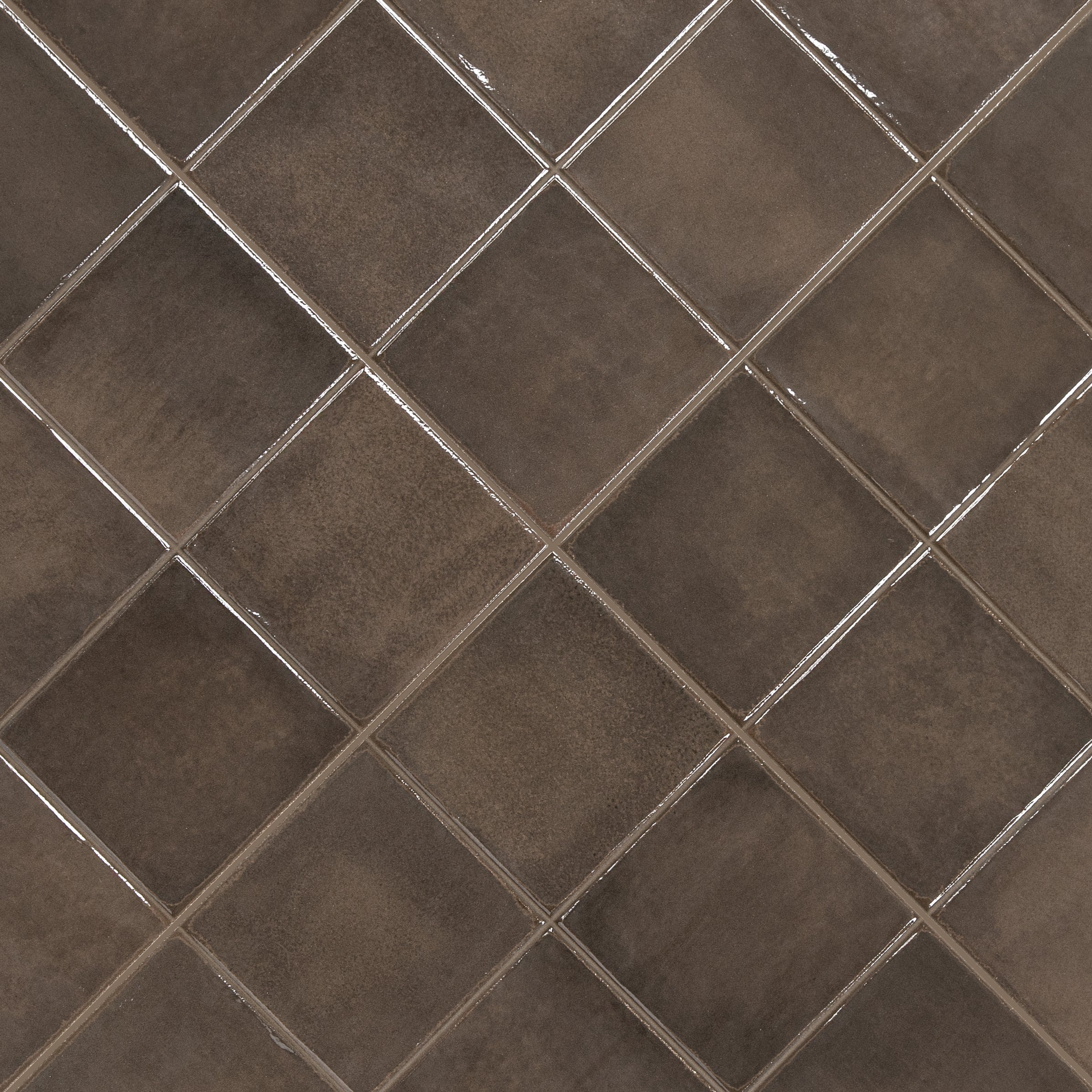 Close-up of matte brown ceramic tiles arranged diagonally with light grout lines.