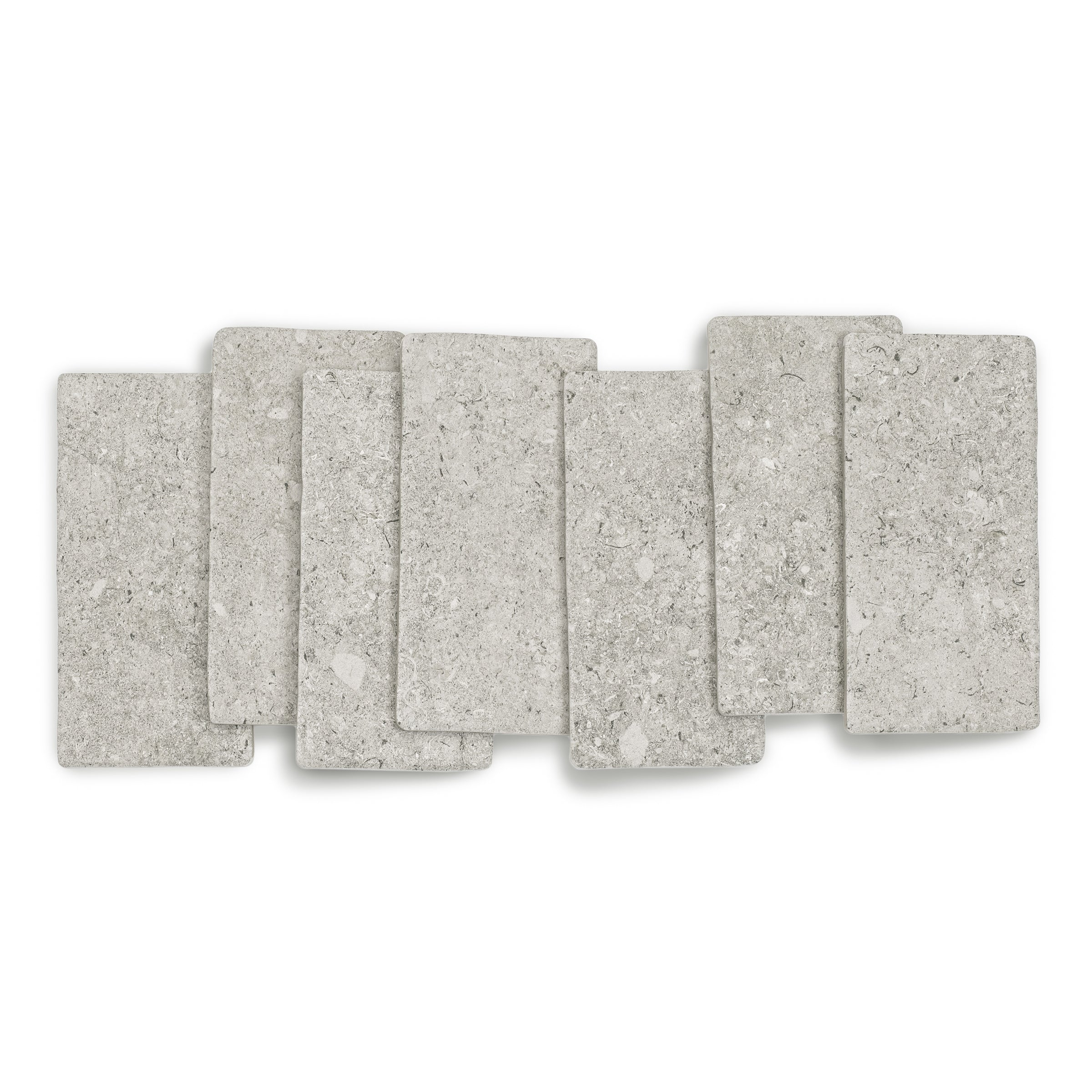 Matte light grey porcelain tiles with natural stone texture arranged in a casual overlapping pattern for flooring or walls